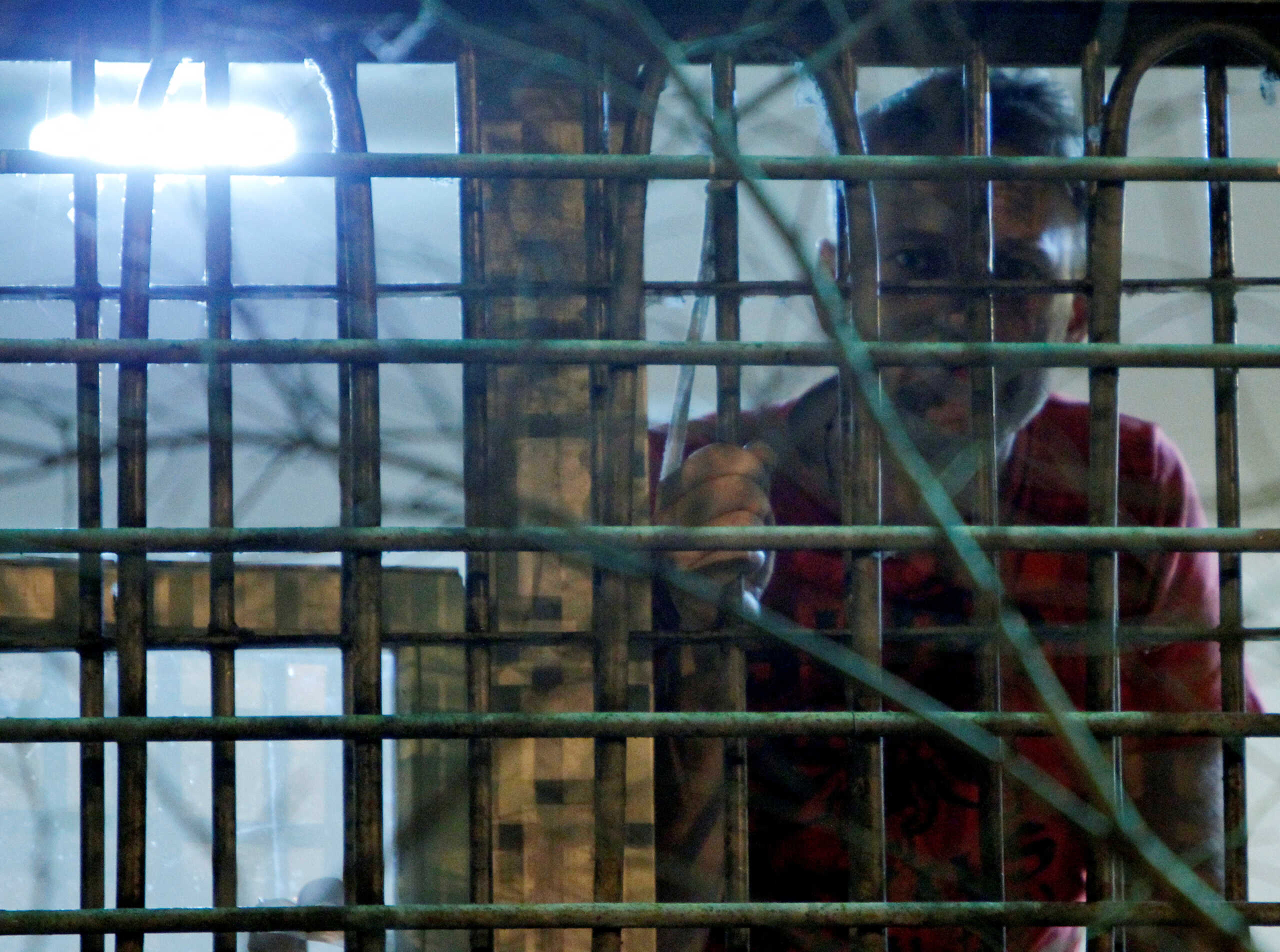FILE PHOTO: Russian anti-corruption blogger Alexei Navalny looks out of the window of his cell in a detention centre in Moscow December 8, 2011.  REUTERS