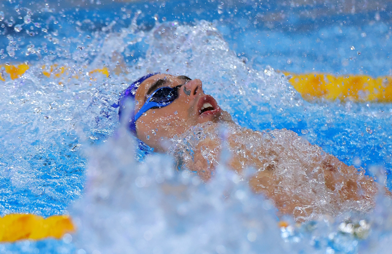 Swimming - World Aquatics Championships - Aspire Dome, Doha, Qatar - February 12, 2024 Greece's Apostolos Christou in action during the men's 100m backstroke - heat 6 REUTERS