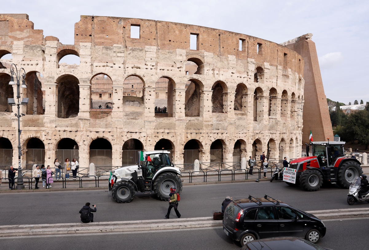 Tractors with the Italian flags attached to them drive past a Colosseum as farmers protest over price pressures, taxes and green regulation, grievances shared by farmers across Europe, in Rome, Italy, February 9, 2024. REUTERS