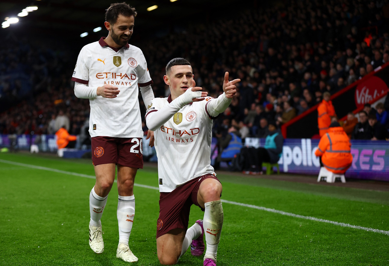 Soccer Football - Premier League - AFC Bournemouth v Manchester City - Vitality Stadium, Bournemouth, Britain - February 24, 2024 Manchester City's Phil Foden celebrates scoring their first goal with Bernardo Silva Action Images via Reuters
