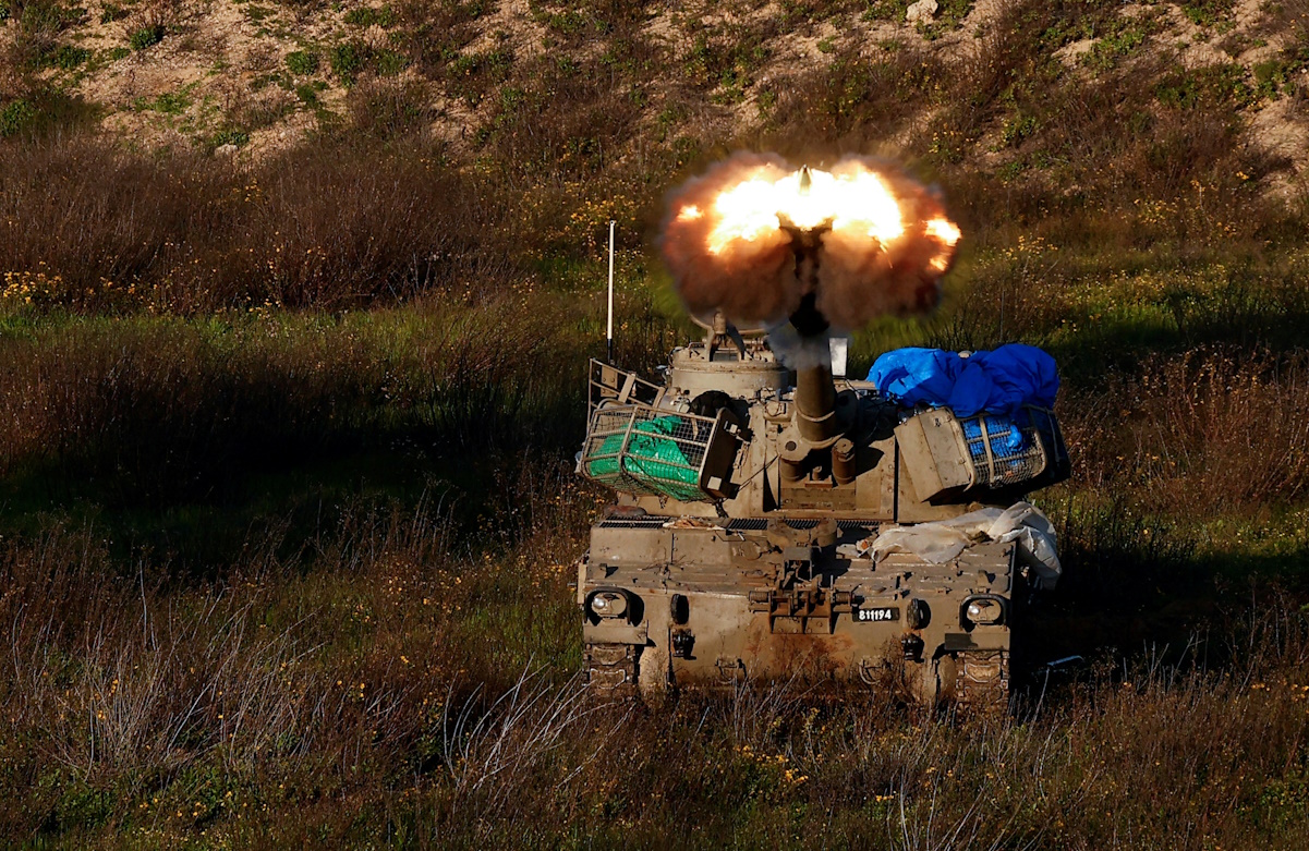 An Israeli artillery unit fires towards Gaza, near the northern Gaza Strip border, amid the ongoing conflict between Israel and the Palestinian Islamist group Hamas, as seen from Israel, February 11, 2024. REUTERS