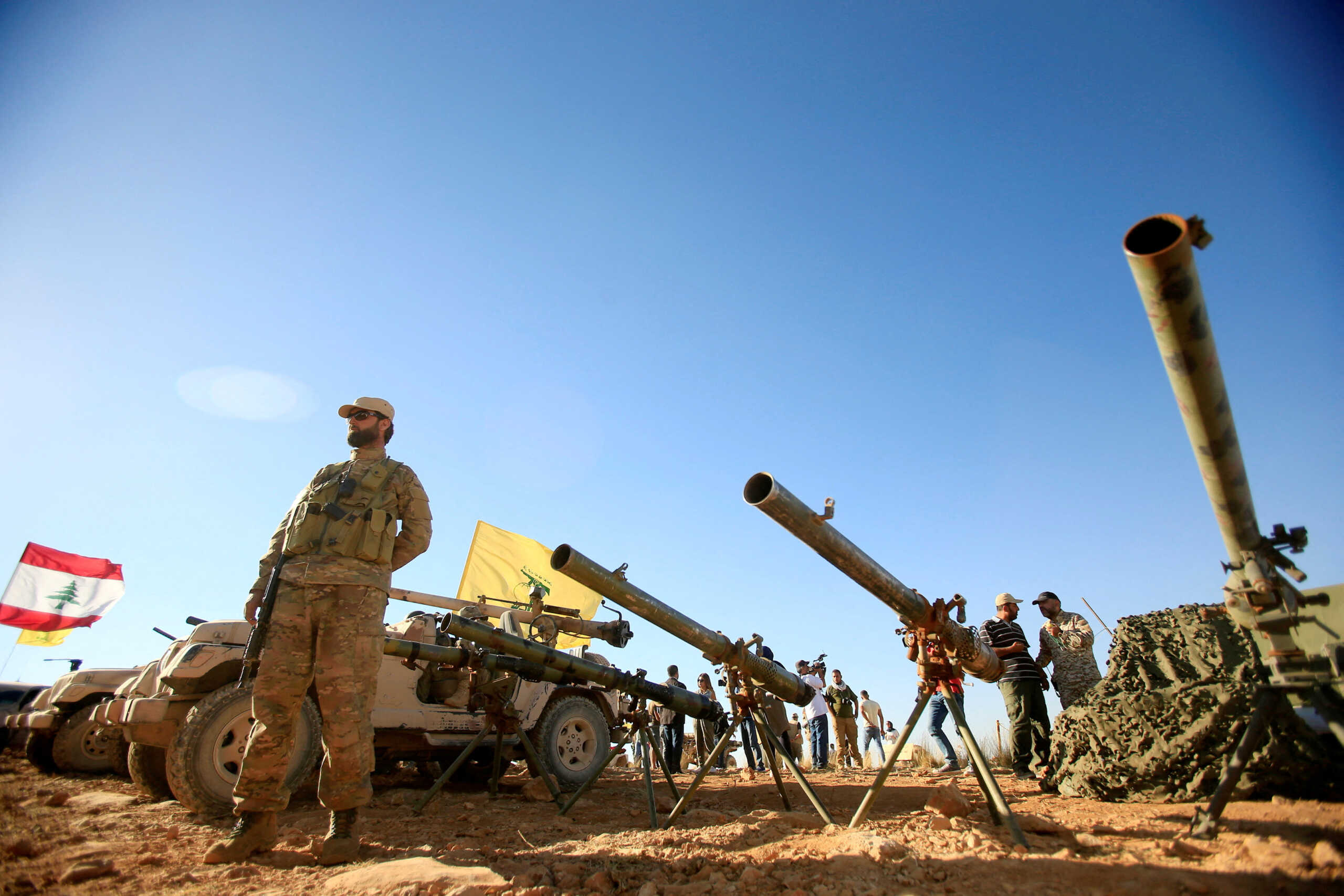 FILE PHOTO: A Hezbollah fighter stands in front of anti-tank artillery at Juroud Arsal, the Syria-Lebanon border, July 29, 2017. REUTERS