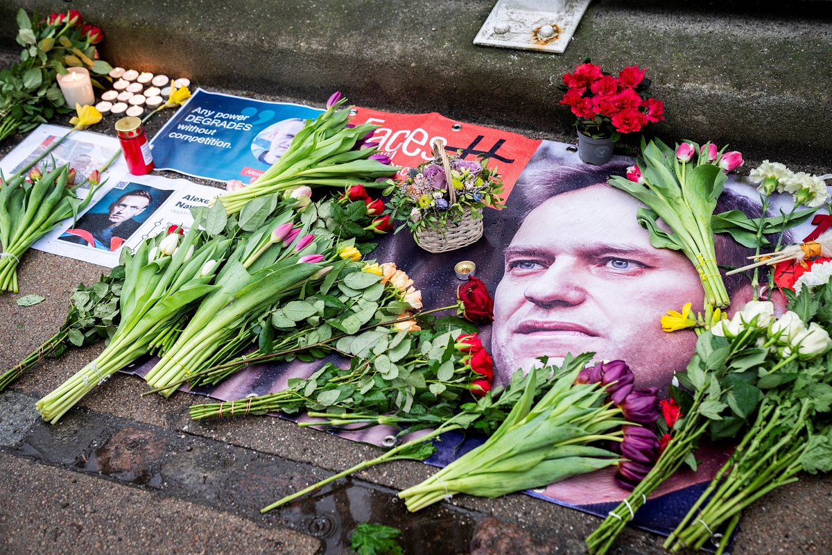 Flowers are placed next to the portraits of Russian opposition leader Alexei Navalny following his death, in front of the Russian embassy in Copenhagen, Denmark February 16, 2024. Ritzau Scanpix