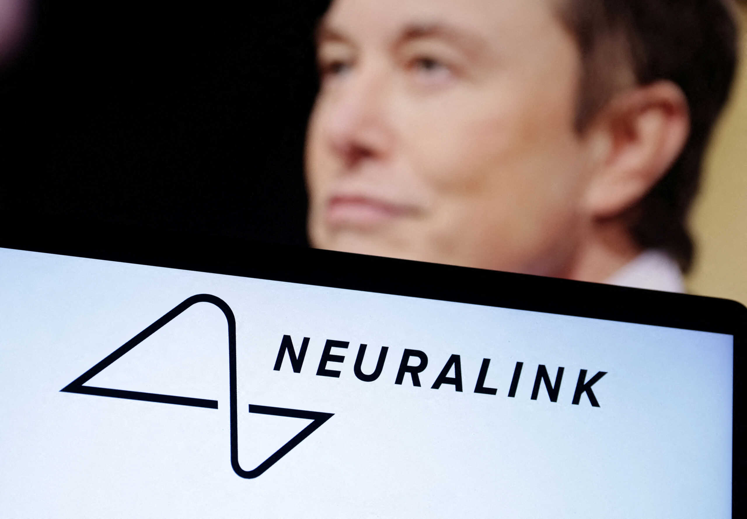 FILE PHOTO: Neuralink logo and Elon Musk photo are seen in this illustration taken, December 19, 2022. REUTERS