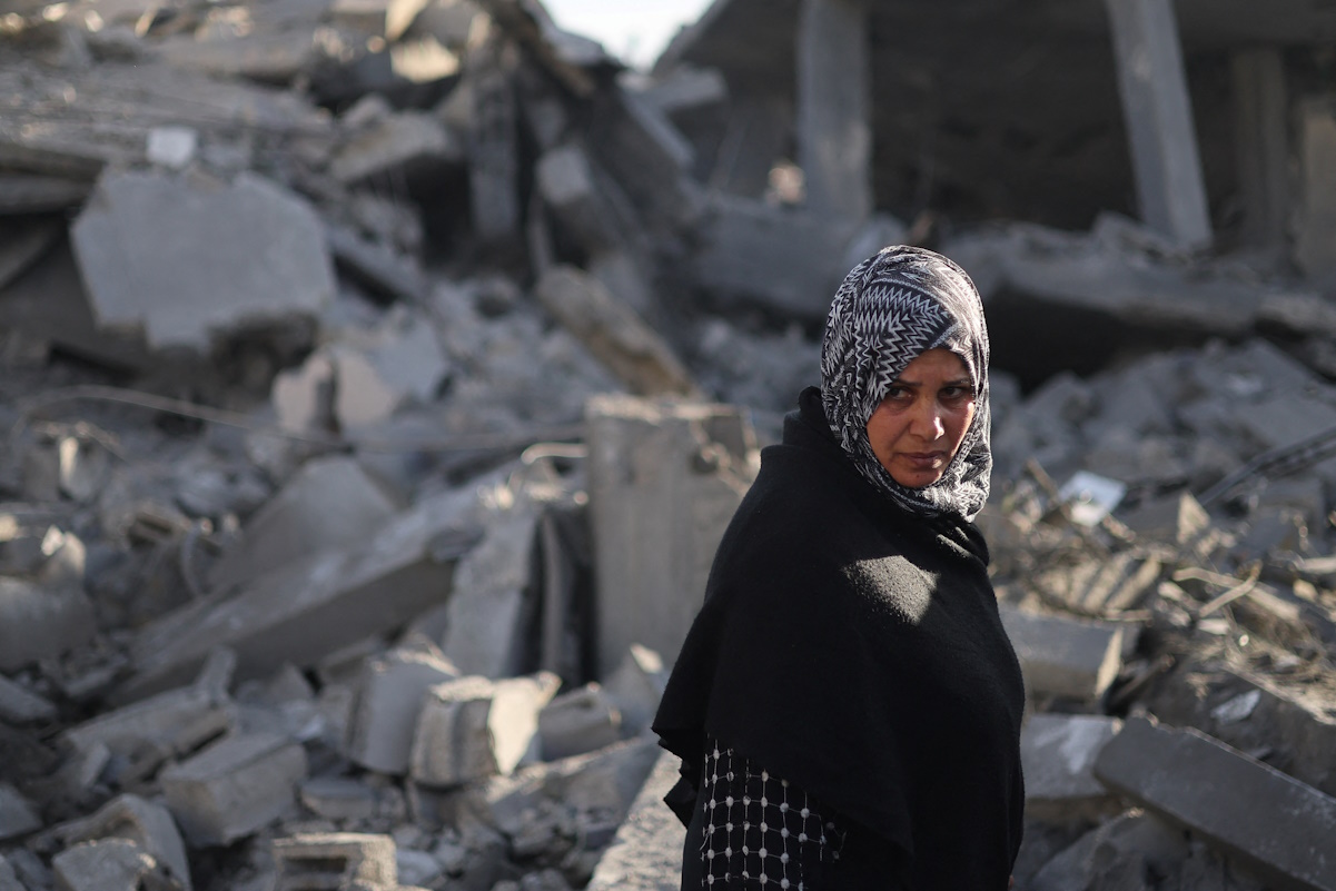 A Palestinian woman looks on, at the site of an Israeli strike on a house, amid the ongoing conflict between Israel and the Palestinian Islamist group Hamas, in Rafah in the southern Gaza Strip, February 12, 2024. REUTERS