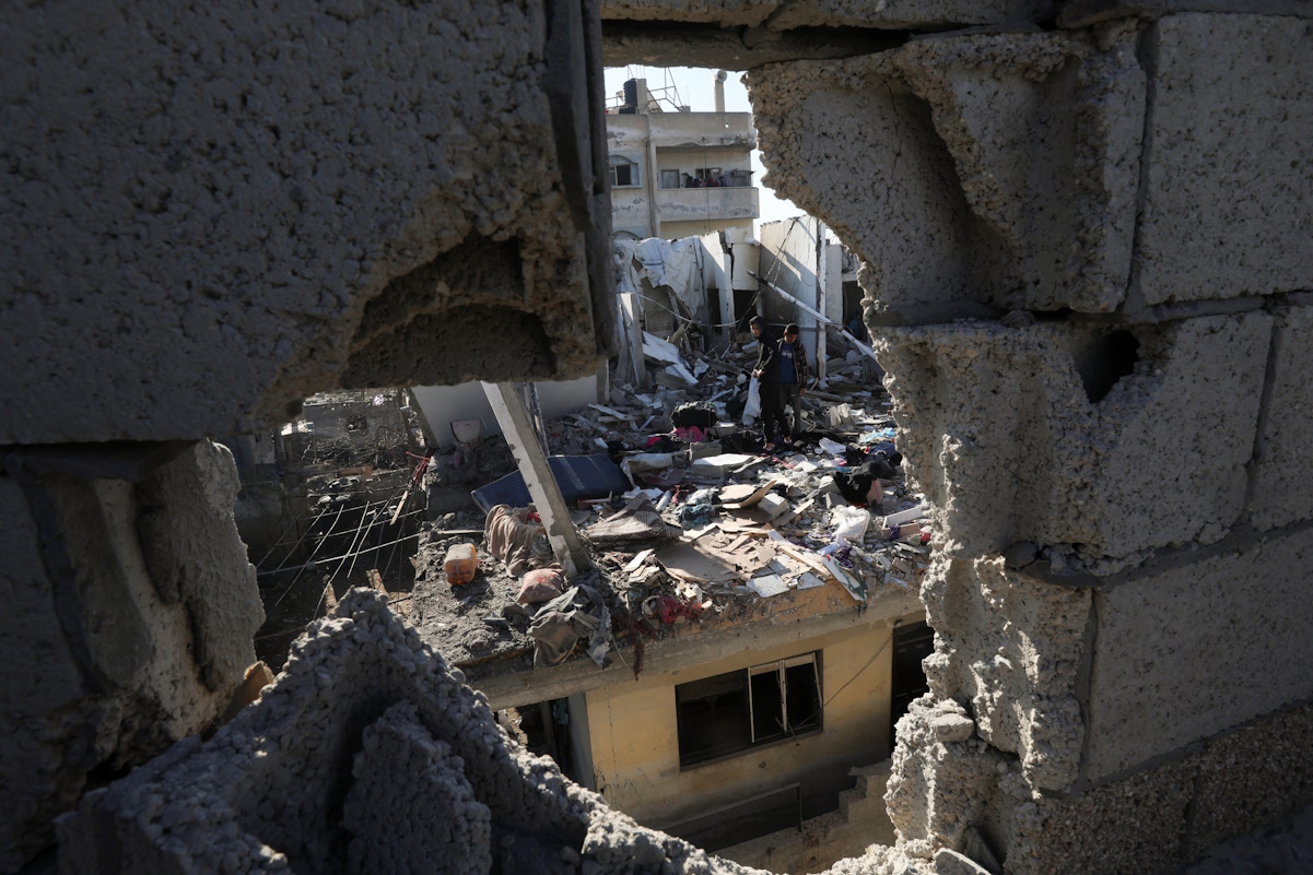Palestinians inspect the site of an Israeli strike on a house, amid the ongoing conflict between Israel and the Palestinian Islamist group Hamas, in Rafah in the southern Gaza Strip, February 7, 2024. REUTERS