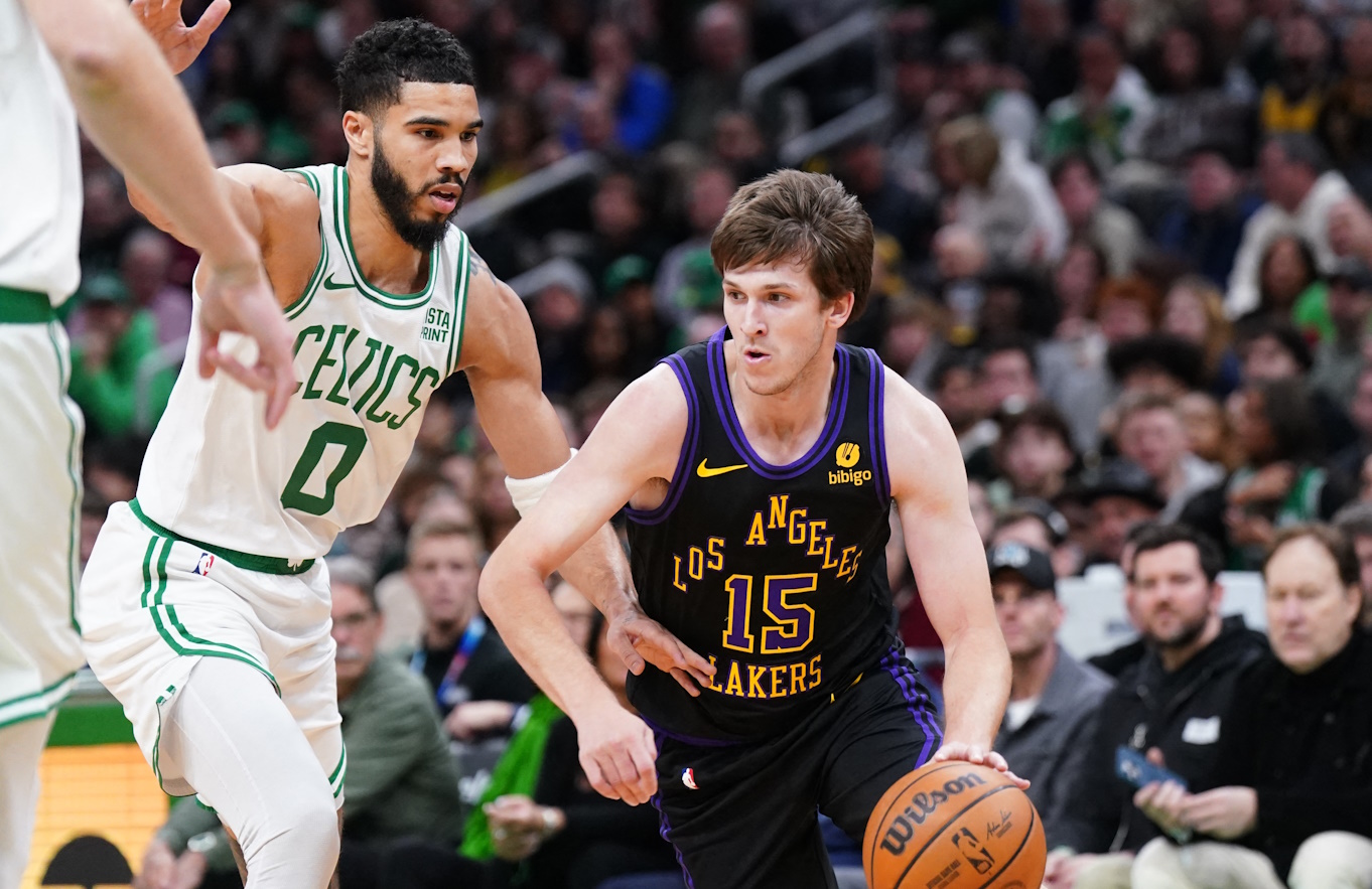 Feb 1, 2024; Boston, Massachusetts, USA; Los Angeles Lakers guard Austin Reaves (15) drives the ball against Boston Celtics forward Jayson Tatum (0) in the first quarter at TD Garden. Mandatory Credit: David Butler II-USA TODAY Sports