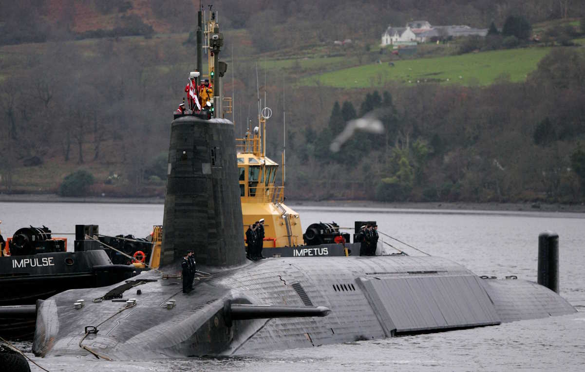 FILE PHOTO: Crew from HMS Vengeance, a British Royal Navy Vanguard class Trident Ballistic Missile Submarine, stand on their vessel as they return along the Clyde river to the Faslane naval base near Glasgow, Scotland December 4, 2006. REUTERS
