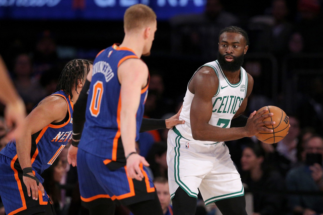 Feb 24, 2024; New York, New York, USA; Boston Celtics guard Jaylen Brown (7) controls the ball against New York Knicks guards Jalen Brunson (11) and Donte DiVincenzo (0) during the third quarter at Madison Square Garden. Mandatory Credit: Brad Penner-USA TODAY Sports