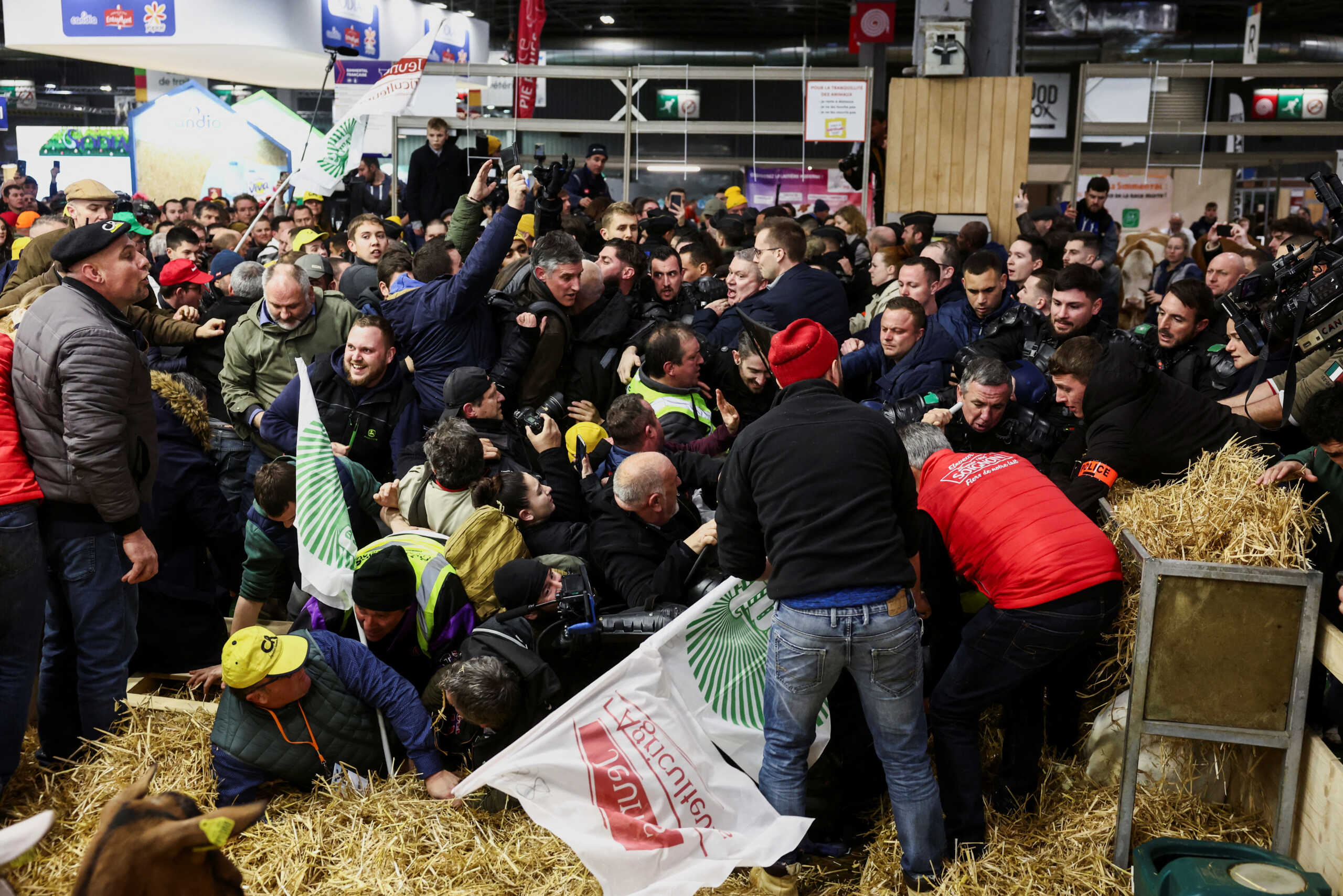 Farmers clash with members of the French police as they protest inside the Porte de Versailles exhibition centre on the day of French President Emmanuel Macron's visit to the International Agriculture Fair (Salon International de l'Agriculture) during its inauguration in Paris, France, February 24, 2024. REUTERS