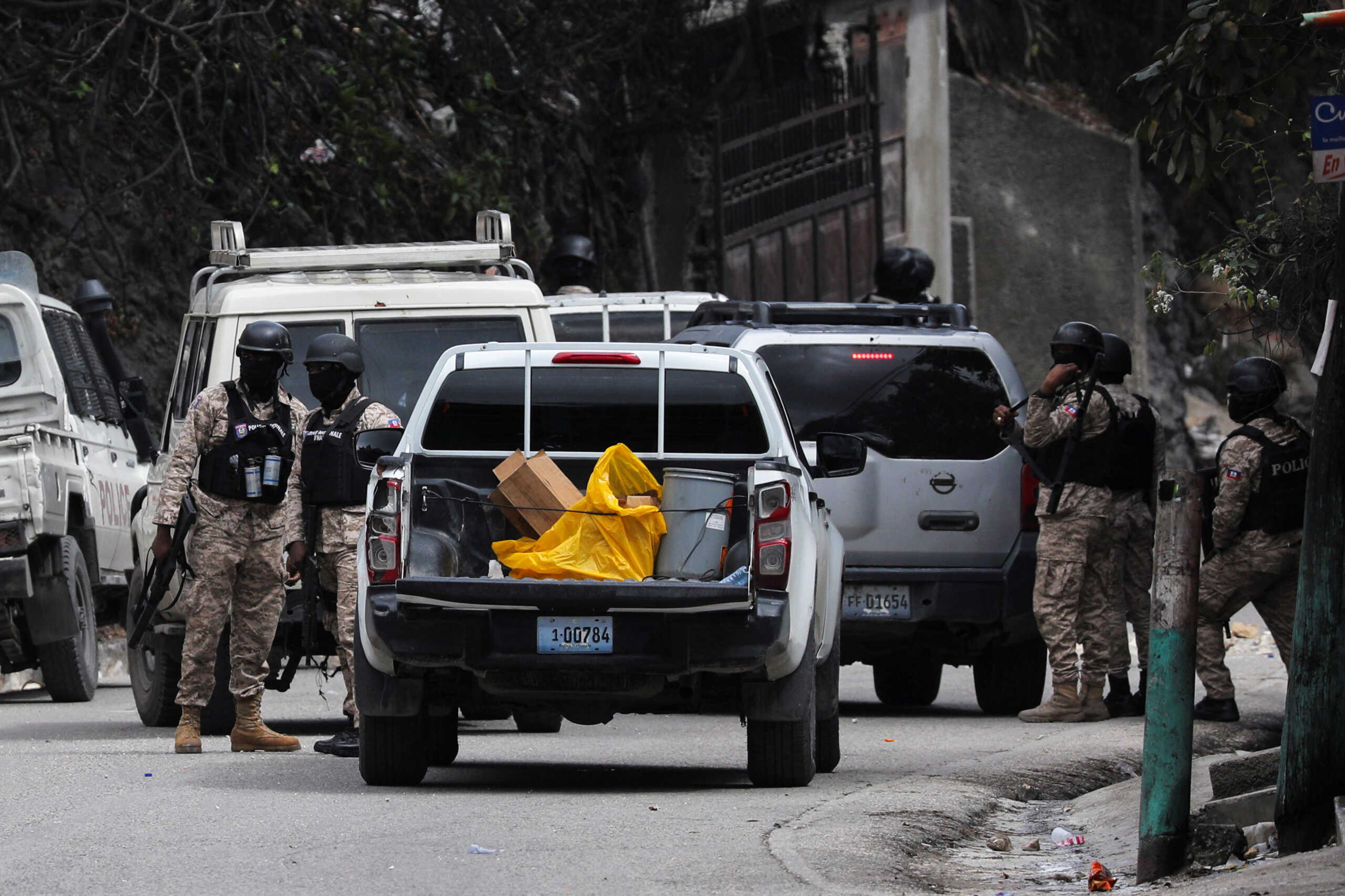 Officers of the Haitian National Police stand at the scene where agents of Haiti's BSAP, an armed environmental agency that has in recent years evolved into a paramilitary body, were killed in a shootout with security forces, in Port-au-Prince, Haiti, February 7, 2024. REUTERS