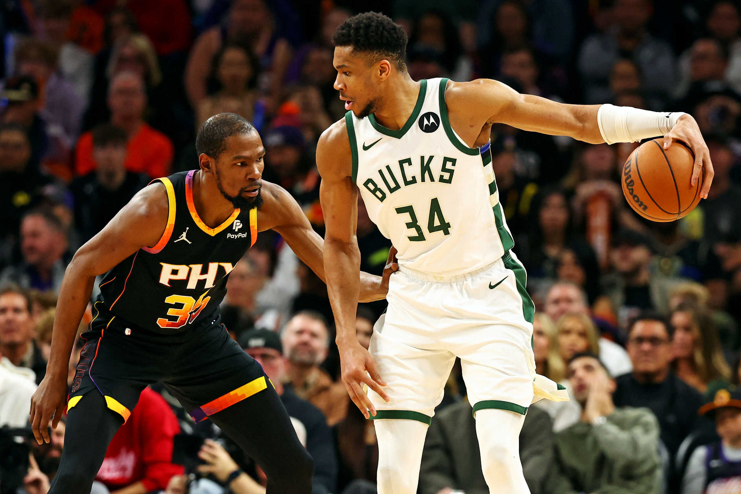 Feb 6, 2024; Phoenix, Arizona, USA; Milwaukee Bucks forward Giannis Antetokounmpo (34) handles the ball against the Phoenix Suns forward Kevin Durant (35) during the third quarter at Footprint Center. Mandatory Credit: Mark J. Rebilas-USA TODAY Sports