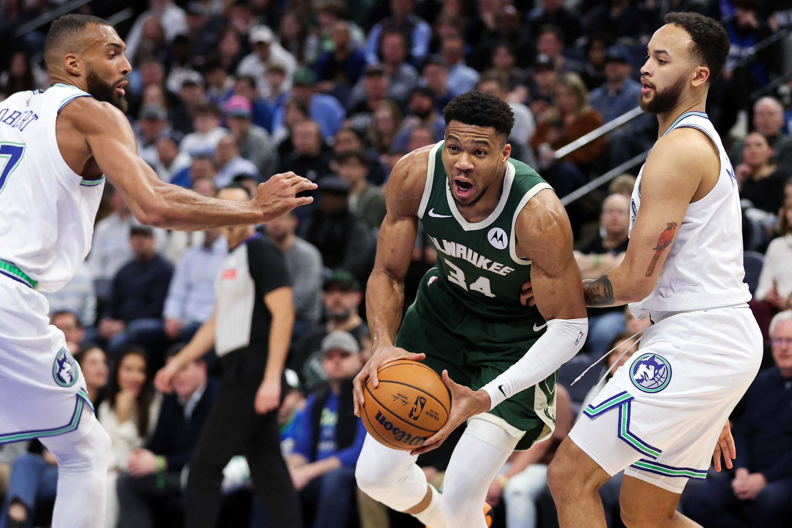 Feb 23, 2024; Minneapolis, Minnesota, USA; Milwaukee Bucks forward Giannis Antetokounmpo (34) works around Minnesota Timberwolves forward Kyle Anderson (1) and center Rudy Gobert (27) during the first half at Target Center. Mandatory Credit: Matt Krohn-USA TODAY Sports