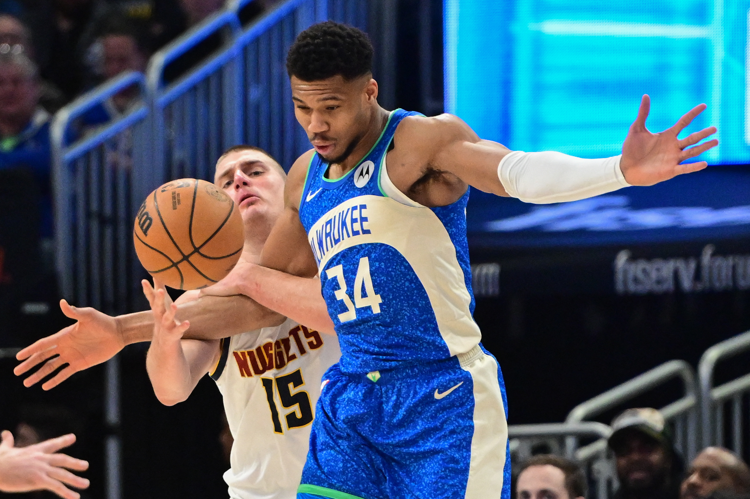 Feb 12, 2024; Milwaukee, Wisconsin, USA; Milwaukee Bucks forward Giannis Antetokounmpo (34) and Denver Nuggets center Nikola Jokic (15) battle for the ball in the second quarter at Fiserv Forum. Mandatory Credit: Benny Sieu-USA TODAY Sports