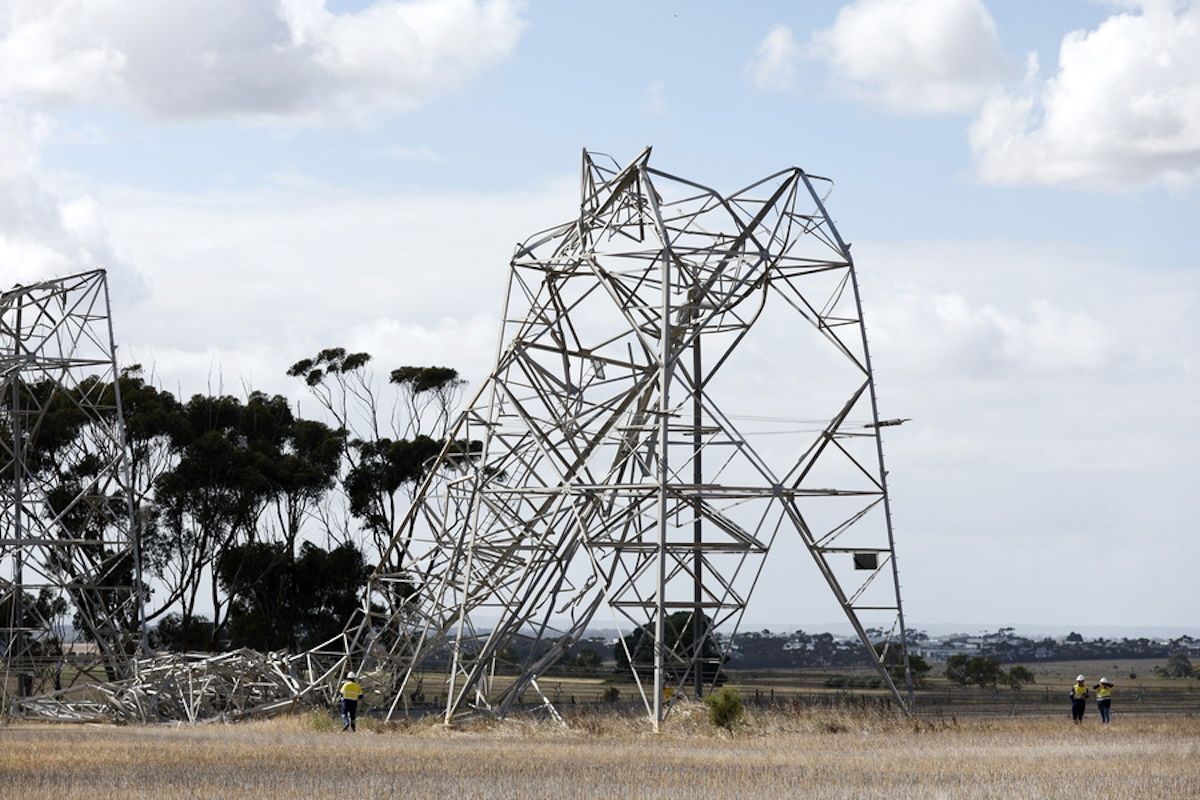 epa11151129 Workers inspect damaged transmission towers at Anakie in Melbourne, Australia 14 February 2024. Thousands of households and businesses remain without power in Victoria after storms knocked down transmission towers following a day of high temperatures.  EPA