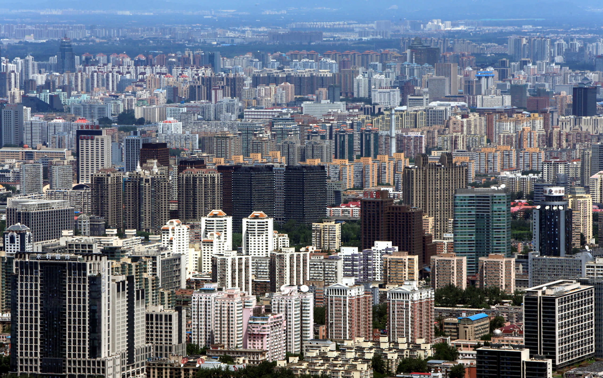 FILE PHOTO: Buildings are seen in Beijing, July 3, 2013. REUTERS