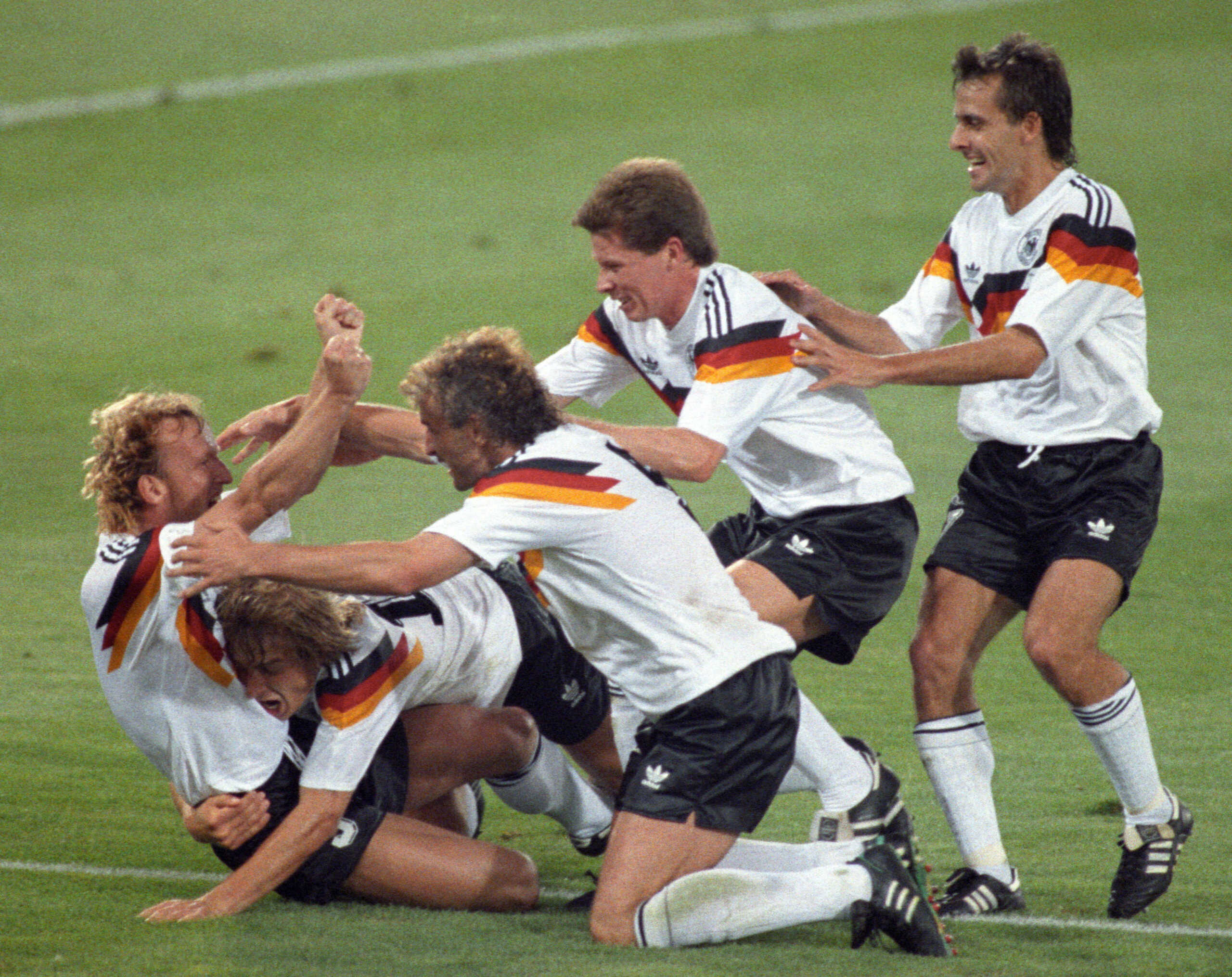 FILE PHOTO: West Germany's Brehme (L) is mobbed by teammates after he scored the only goal of the World Cup final against Argentina on a penalty kick July 8, 1990 in Rome, Italy.    REUTERS