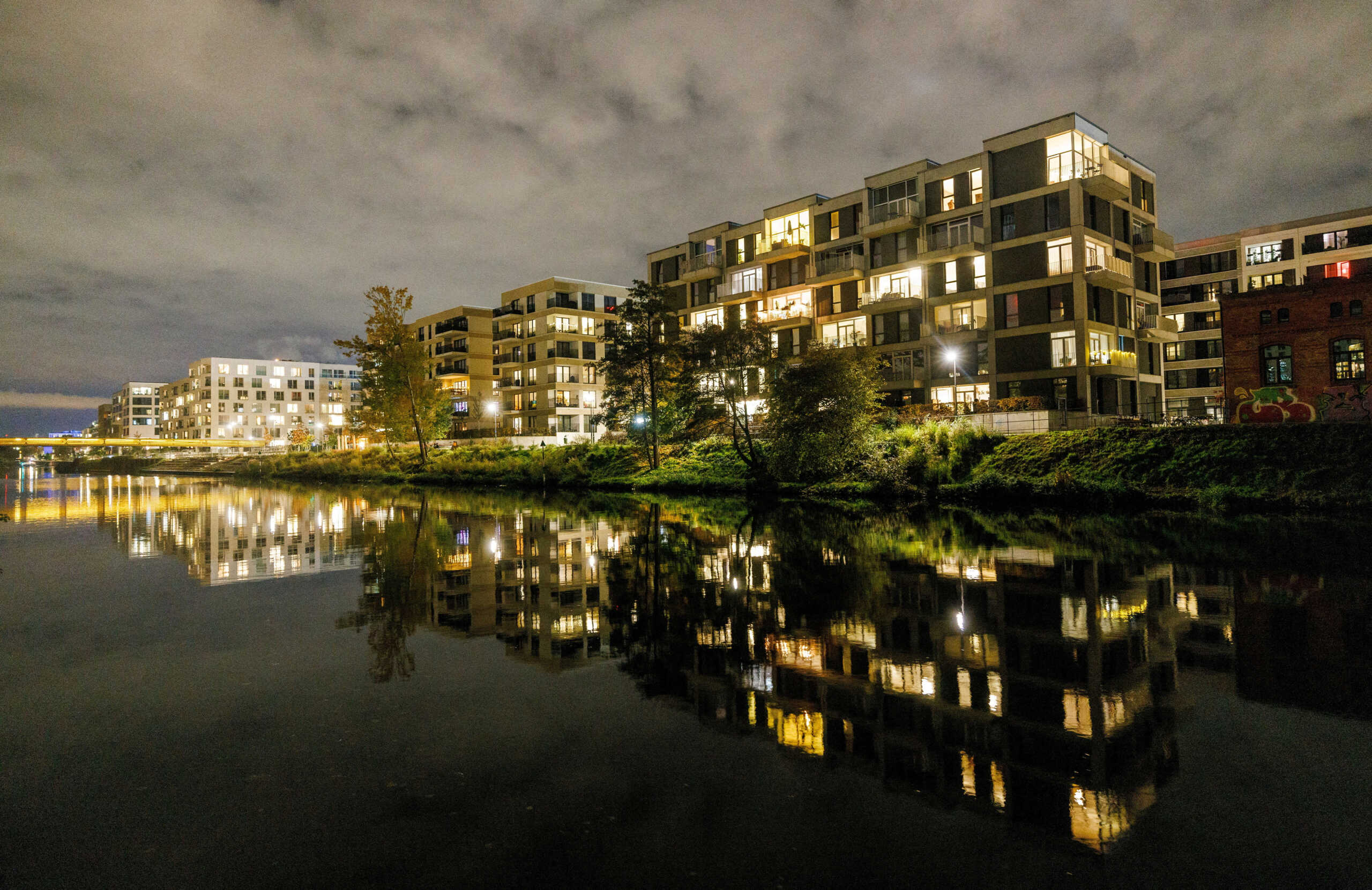 FILE PHOTO: Apartments are illuminated inside residential buildings at the bank of Berlin-Spandauer-Schifffahrtskanal in Berlin, Germany, November 10, 2023. REUTERS