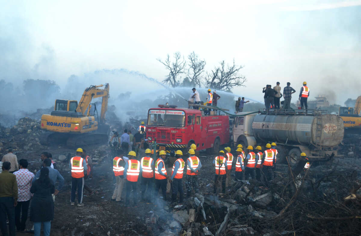 Rescue members from State Disaster Response Force (SDRF) douse the smoldering debris following a blast in a firecracker factory in Harda, Madhya Pradesh, India, February 6, 2024. REUTERS