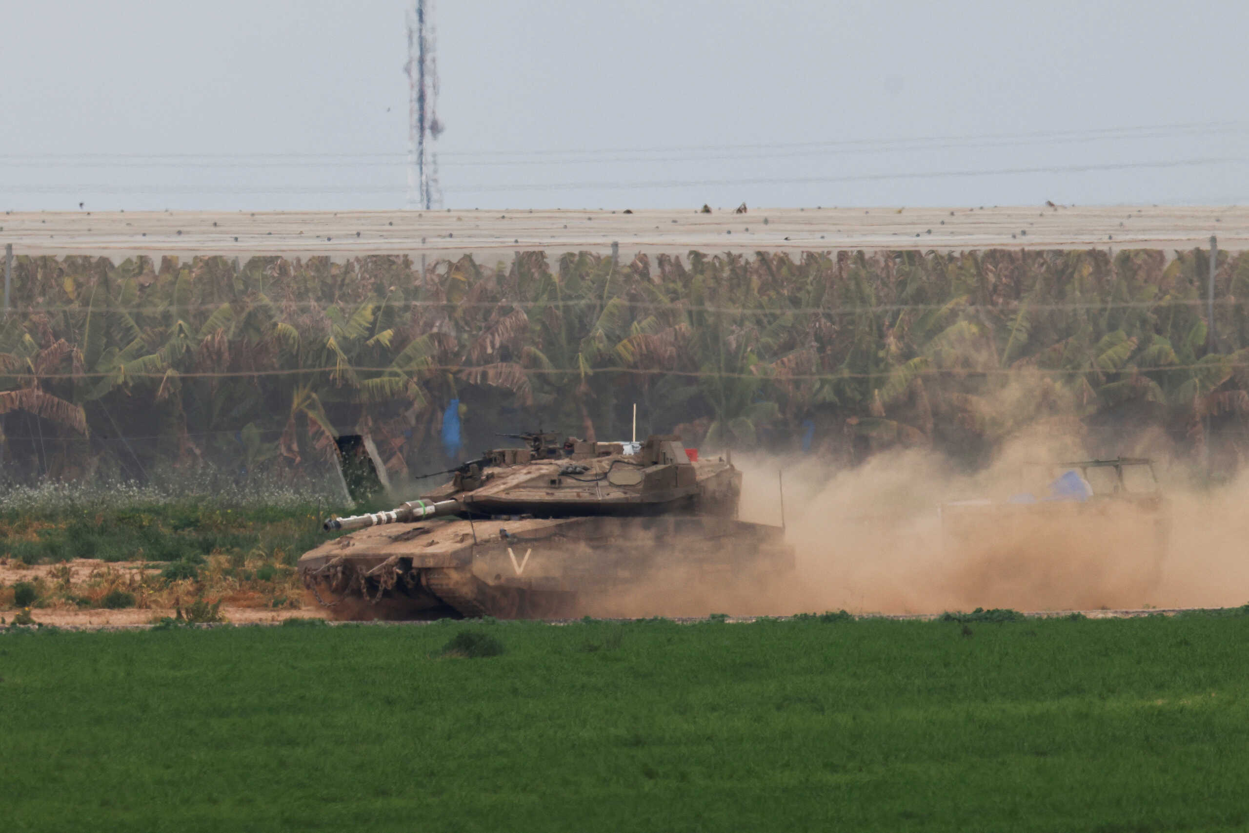 An Israeli tank maneuvers near the Israel-Gaza border, amid the ongoing conflict between Israel and the Palestinian Islamist group Hamas, as seen from Israel, February 23, 2024. REUTERS