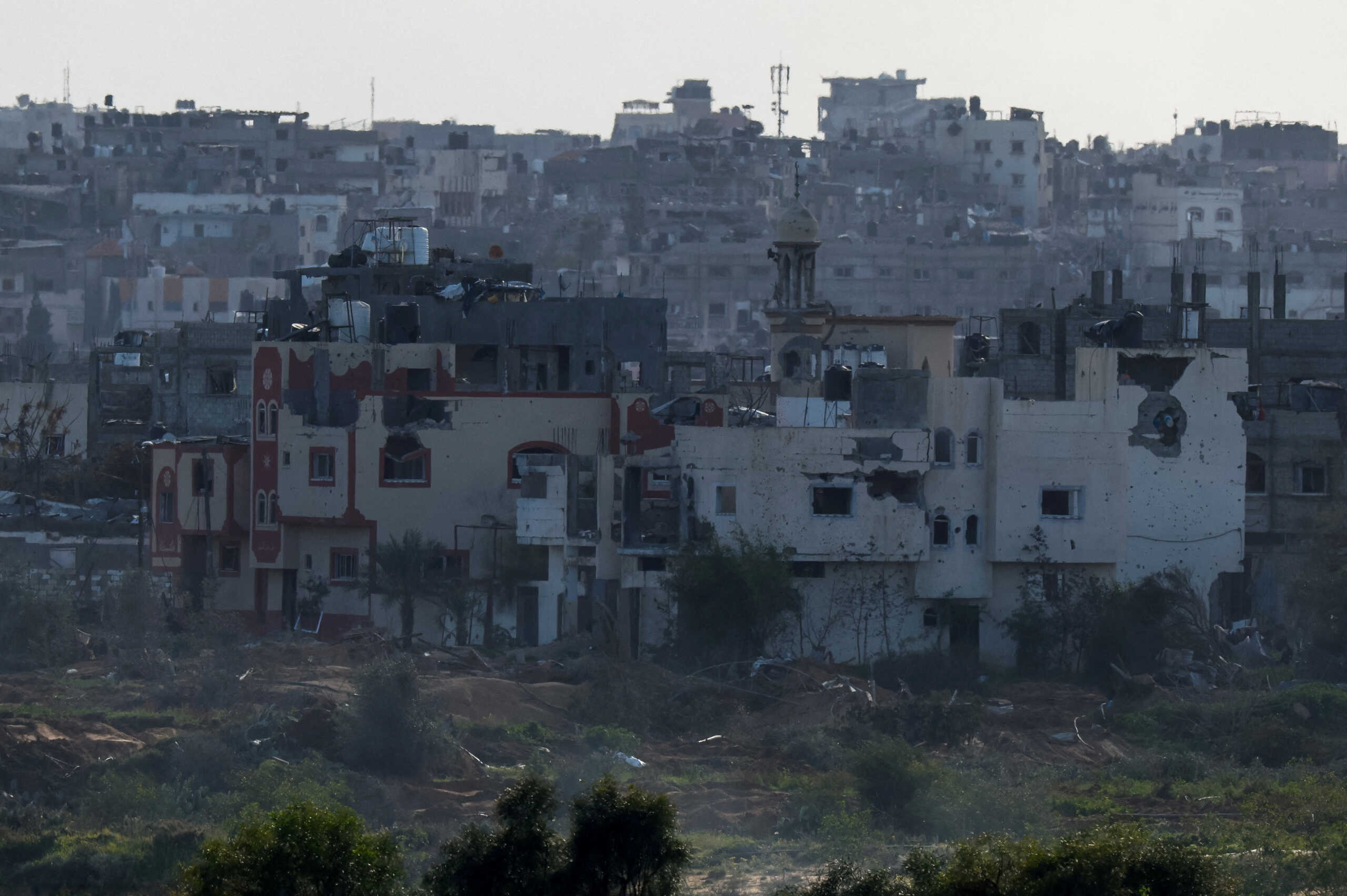 Damaged houses lie in ruin in northern Gaza, amid the ongoing conflict between Israel and the Palestinian Islamist group Hamas, as seen from Israel, February 15, 2024. REUTERS
