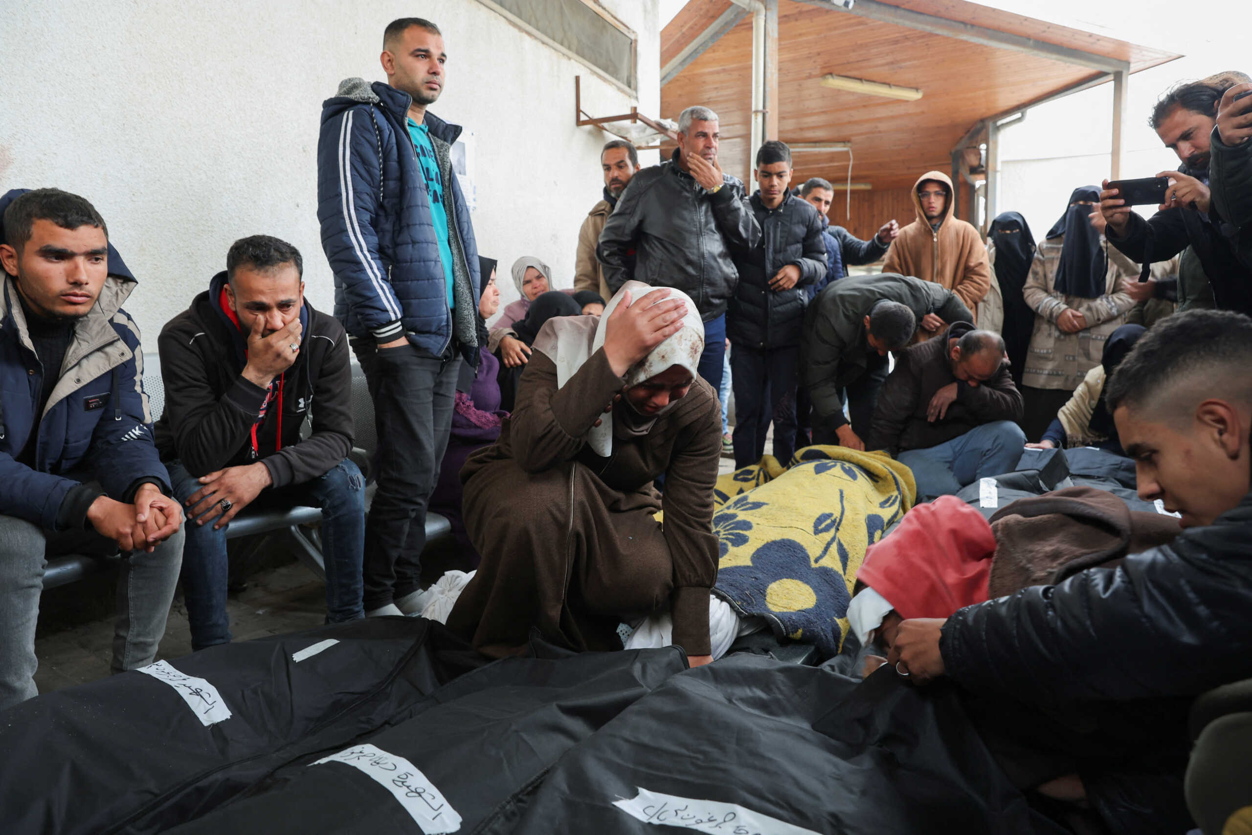 Mourners react next to the bodies of Palestinians killed in Israeli strikes, amid the ongoing conflict between Israel and the Palestinian Islamist group Hamas, at Abu Yousef Al-Najjar hospital in Rafah in the southern Gaza Strip February 23, 2024. REUTERS