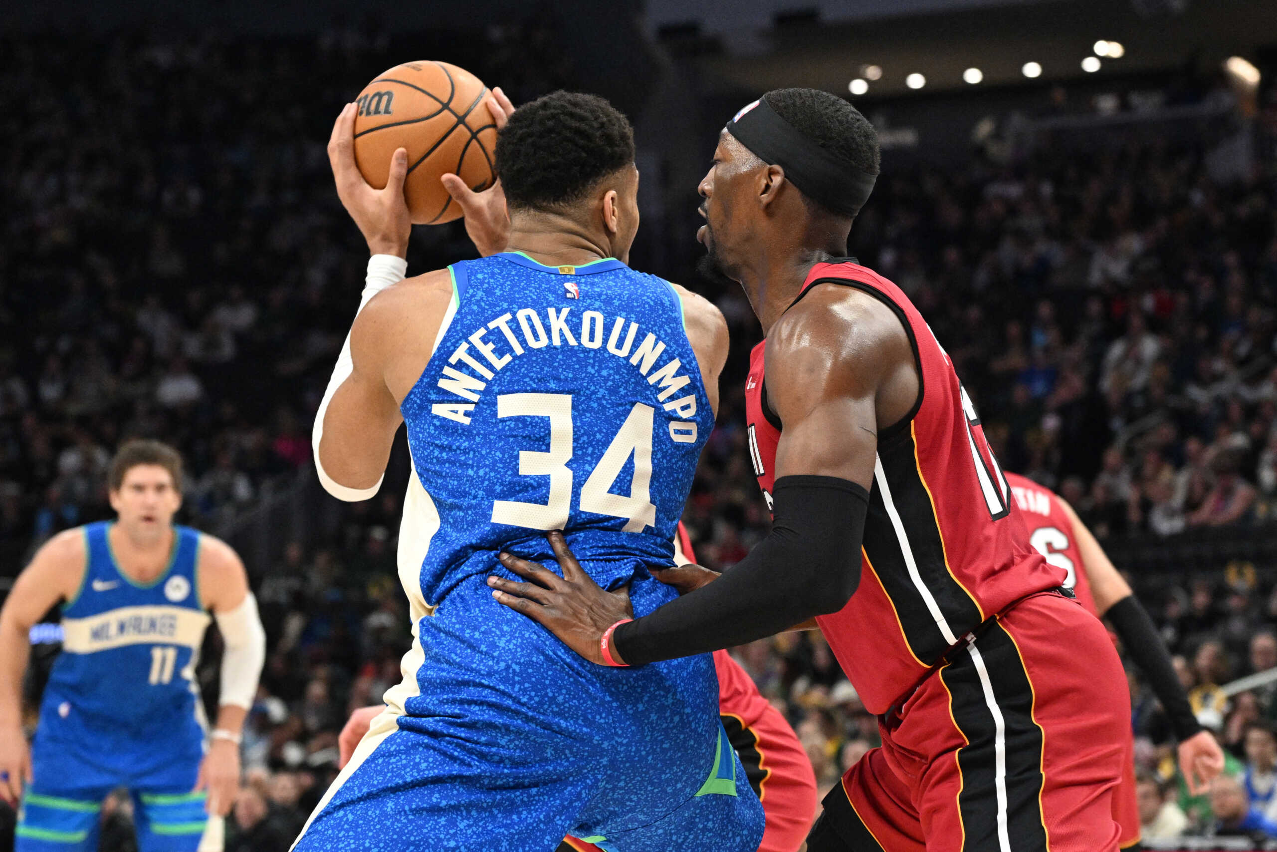 Feb 13, 2024; Milwaukee, Wisconsin, USA; Milwaukee Bucks forward Giannis Antetokounmpo (34) drives against Miami Heat center Bam Adebayo (13) in the first half at Fiserv Forum. Mandatory Credit: Michael McLoone-USA TODAY Sports