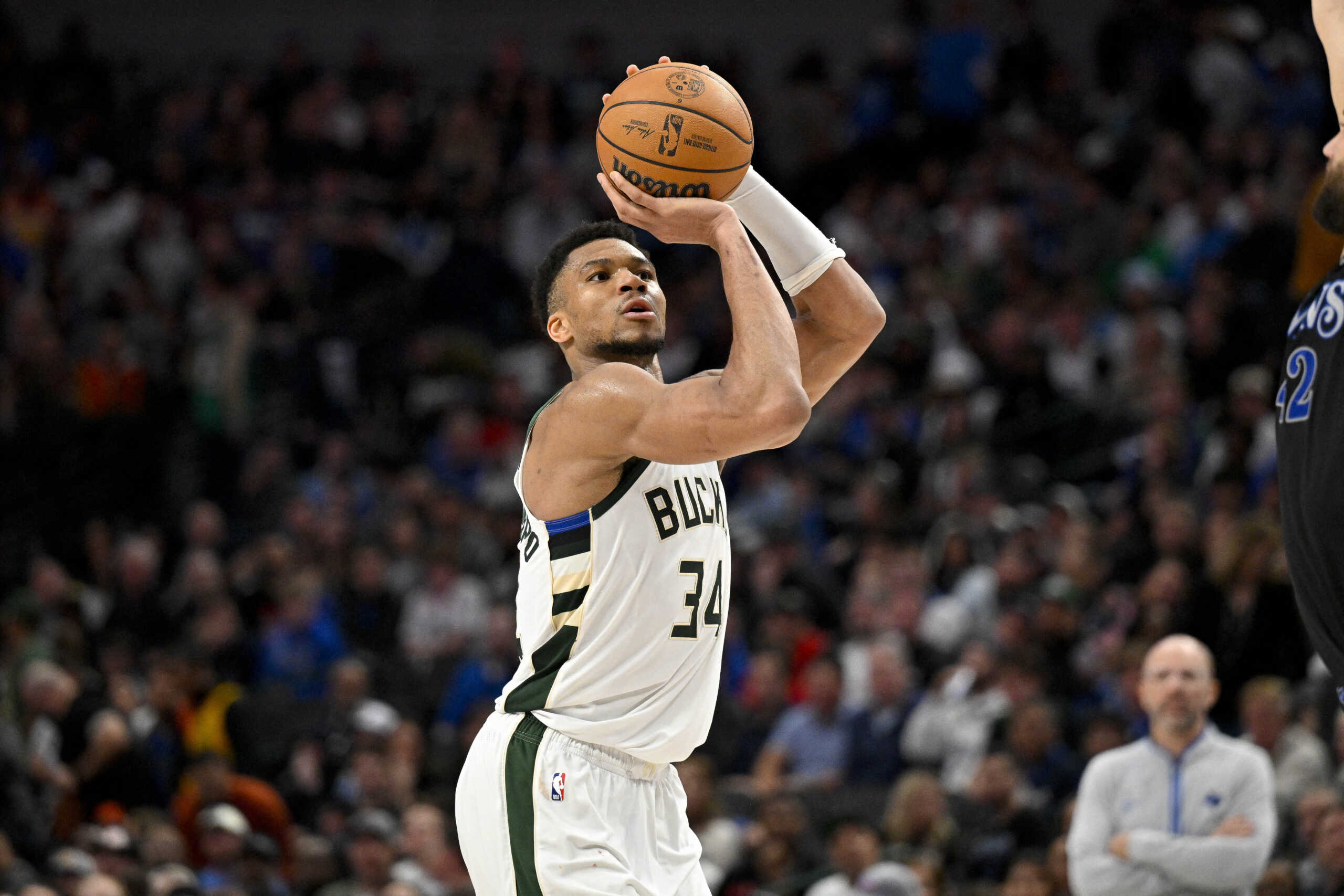 Feb 3, 2024; Dallas, Texas, USA; Milwaukee Bucks forward Giannis Antetokounmpo (34) makes a three point shot against the Dallas Mavericks during the second half at the American Airlines Center. Mandatory Credit: Jerome Miron-USA TODAY Sports