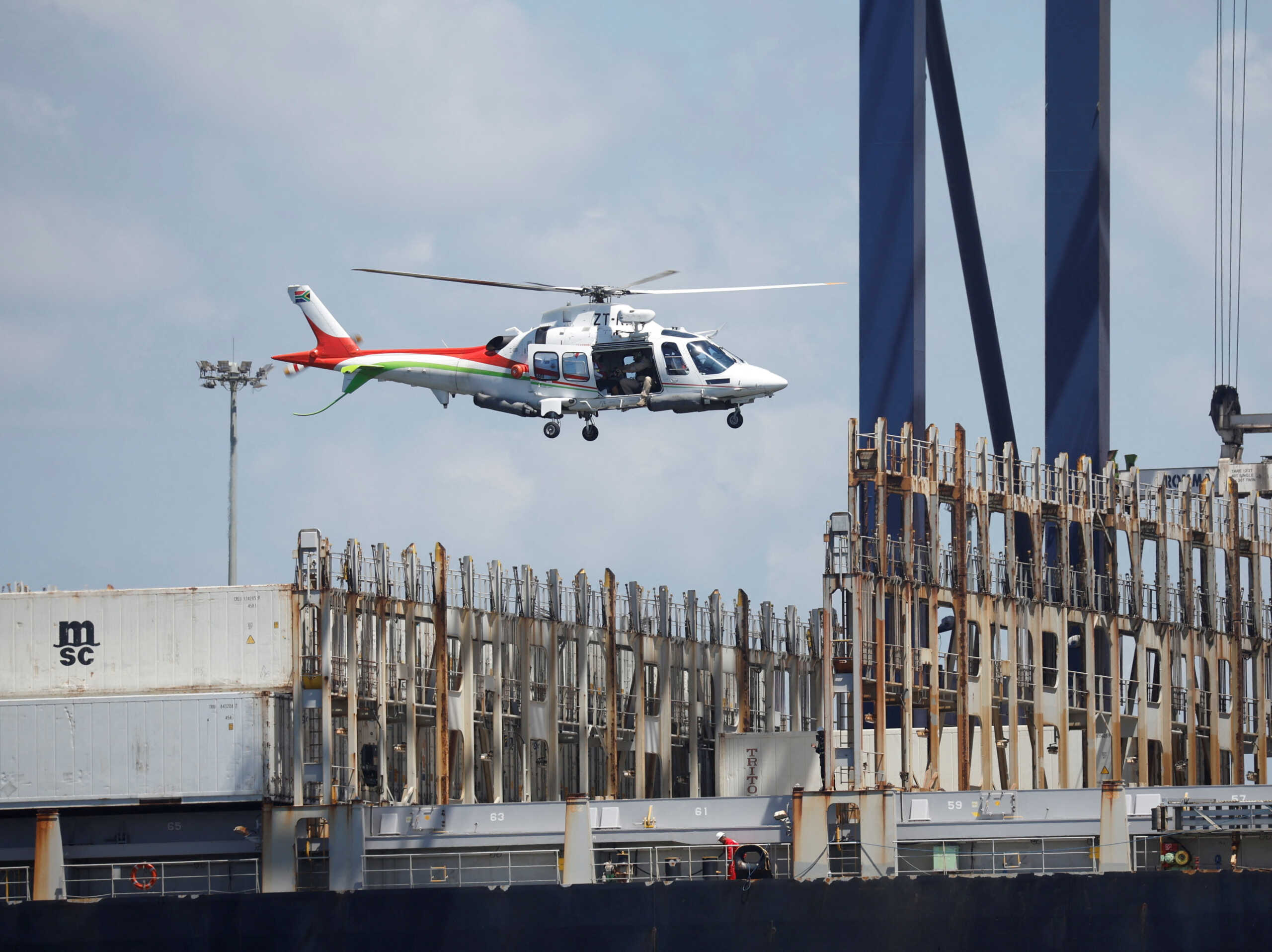 A port helicopter collects the harbour pilot after docking a container vessel at the port in Durban, South Africa, January 31, 2024. REUTERS