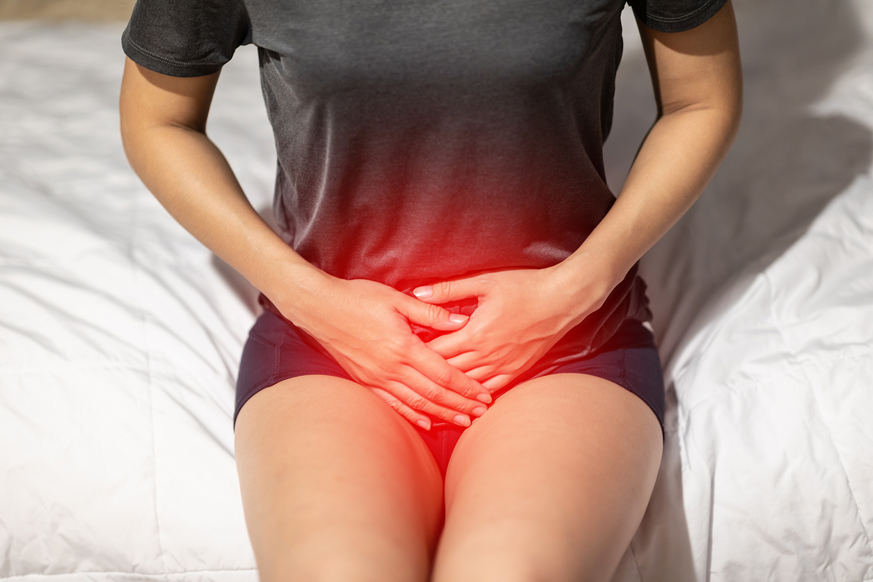 woman have bladder or uti pain sitting on bed in bedroom after wake up feeling so illness,Healthcare concept