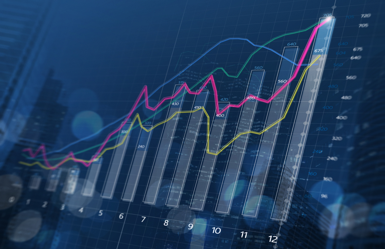 Business growth, progress or success concept. Financial bar chart and growing graphs with depth of field on dark blue background.