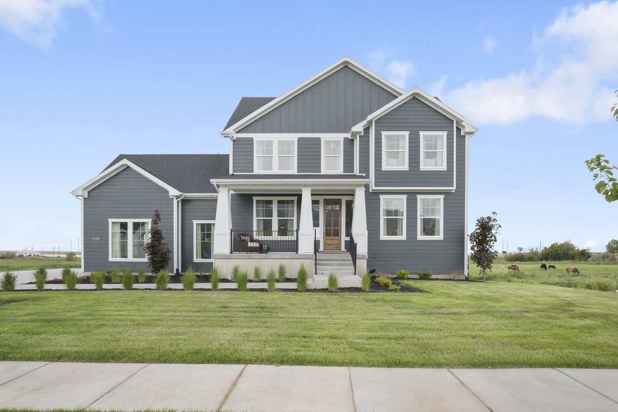Gray and white home on the countryside with lots of property land