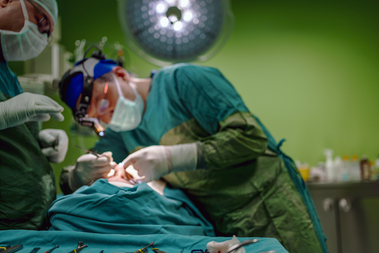 Young male plastic surgeon operates in the operating room of a medical center