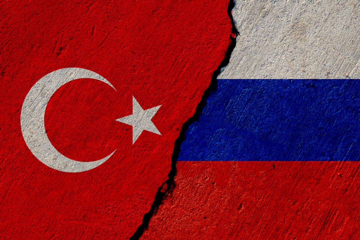 turkish and russian flags painted on cracked concrete wall, turkey and russia conflict or partnership concept