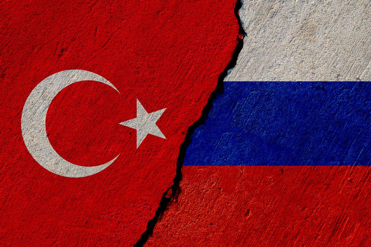 turkish and russian flags painted on cracked concrete wall, turkey and russia conflict or partnership concept