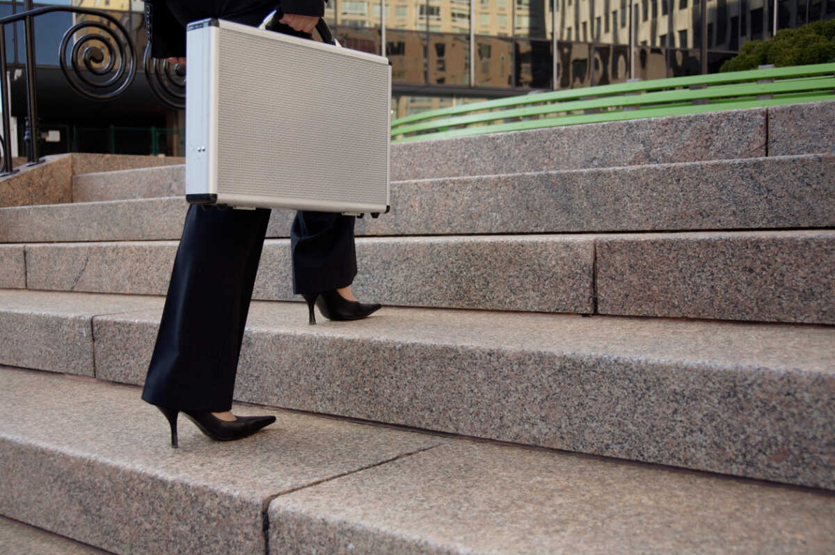 Business woman walking up stairs