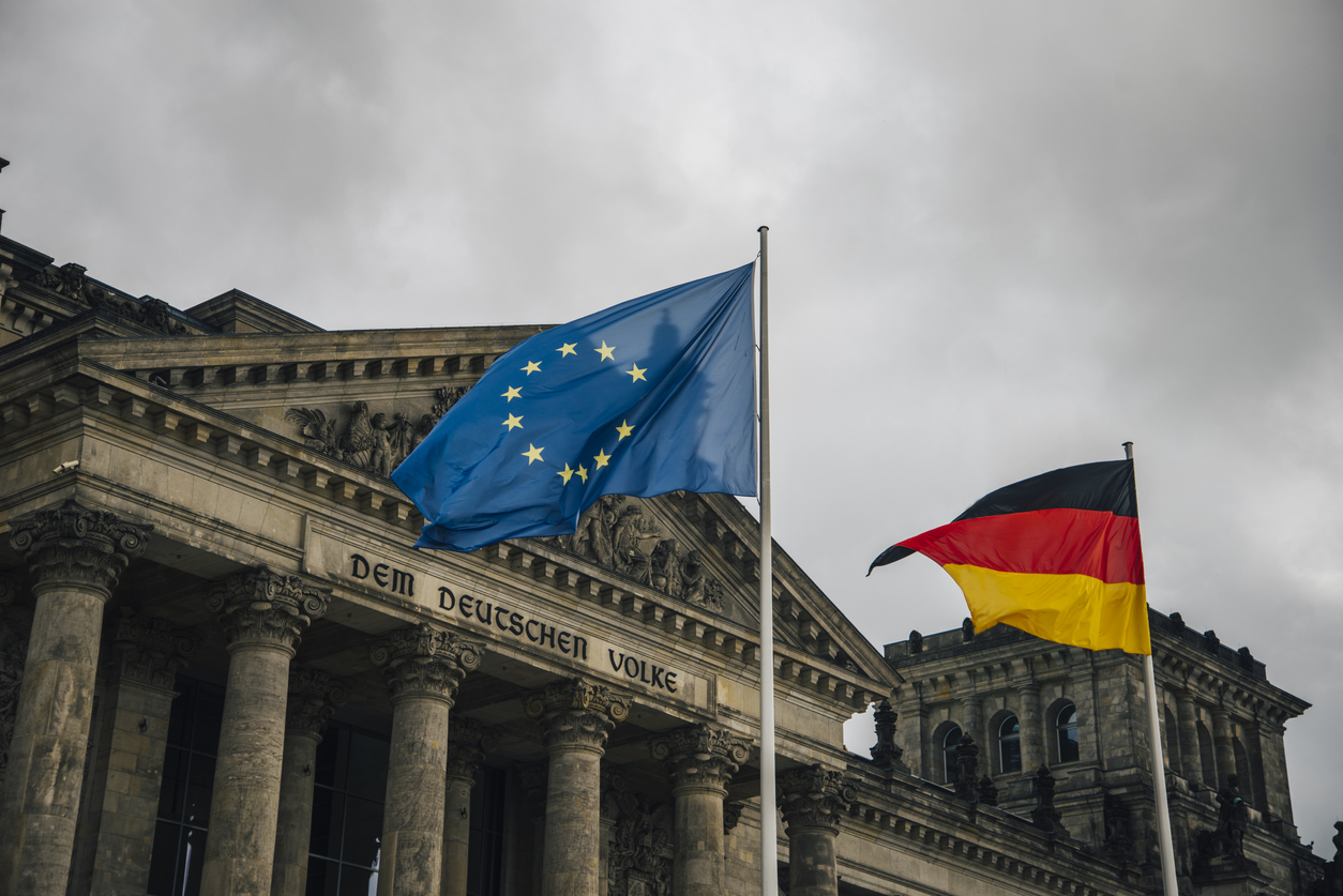 The Reichstag building in Berlin, Germany, with a gernan and a european union flag.