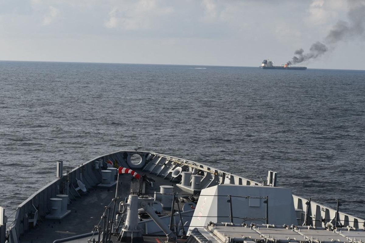 Indian Navy's guided missile destroyer INS Visakhapatnam responds as smoke rises from Marlin Luanda, merchant vessel, after the vessel was struck by a Houthi anti-ship missile, at the location given as Gulf of Aden, in this handout picture released January 27, 2024. @indiannavy via X