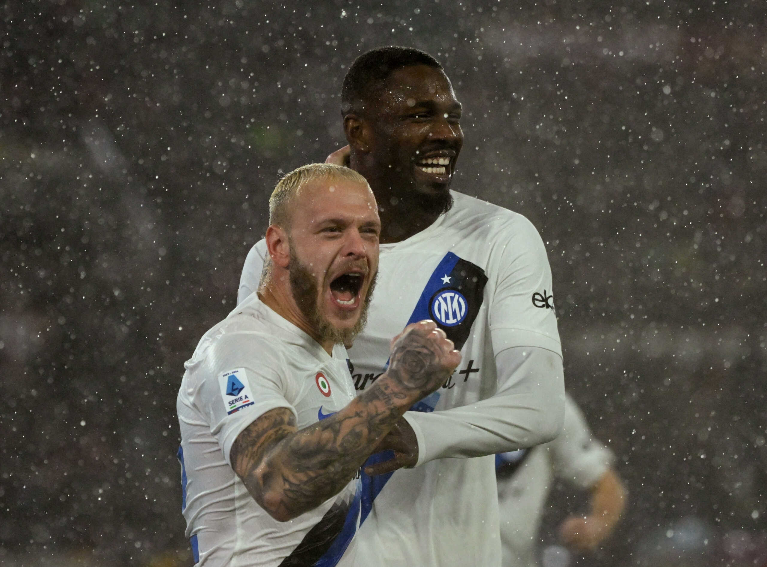 Soccer Football - Serie A - AS Roma v Inter Milan - Stadio Olimpico, Rome, Italy - February 10, 2024 Inter Milan's Marcus Thuram and Federico Dimarco celebrate after AS Roma's Angelino scores an own goal and third for Inter Milan REUTERS
