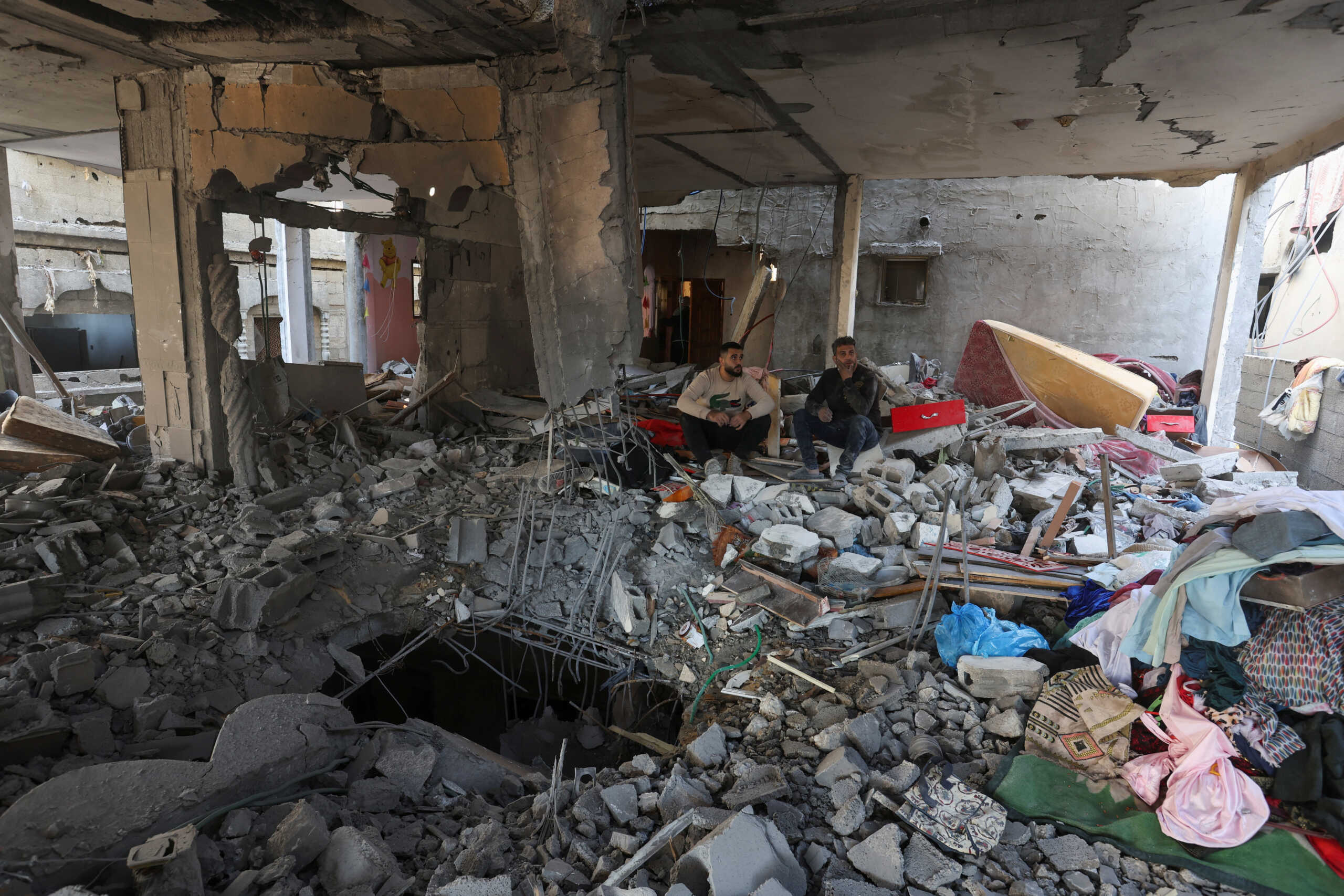 Palestinians inspect the site of an Israeli strike on a house, amid the ongoing conflict between Israel and the Palestinian Islamist group Hamas, in Rafah in the southern Gaza Strip, February 8, 2024. REUTERS