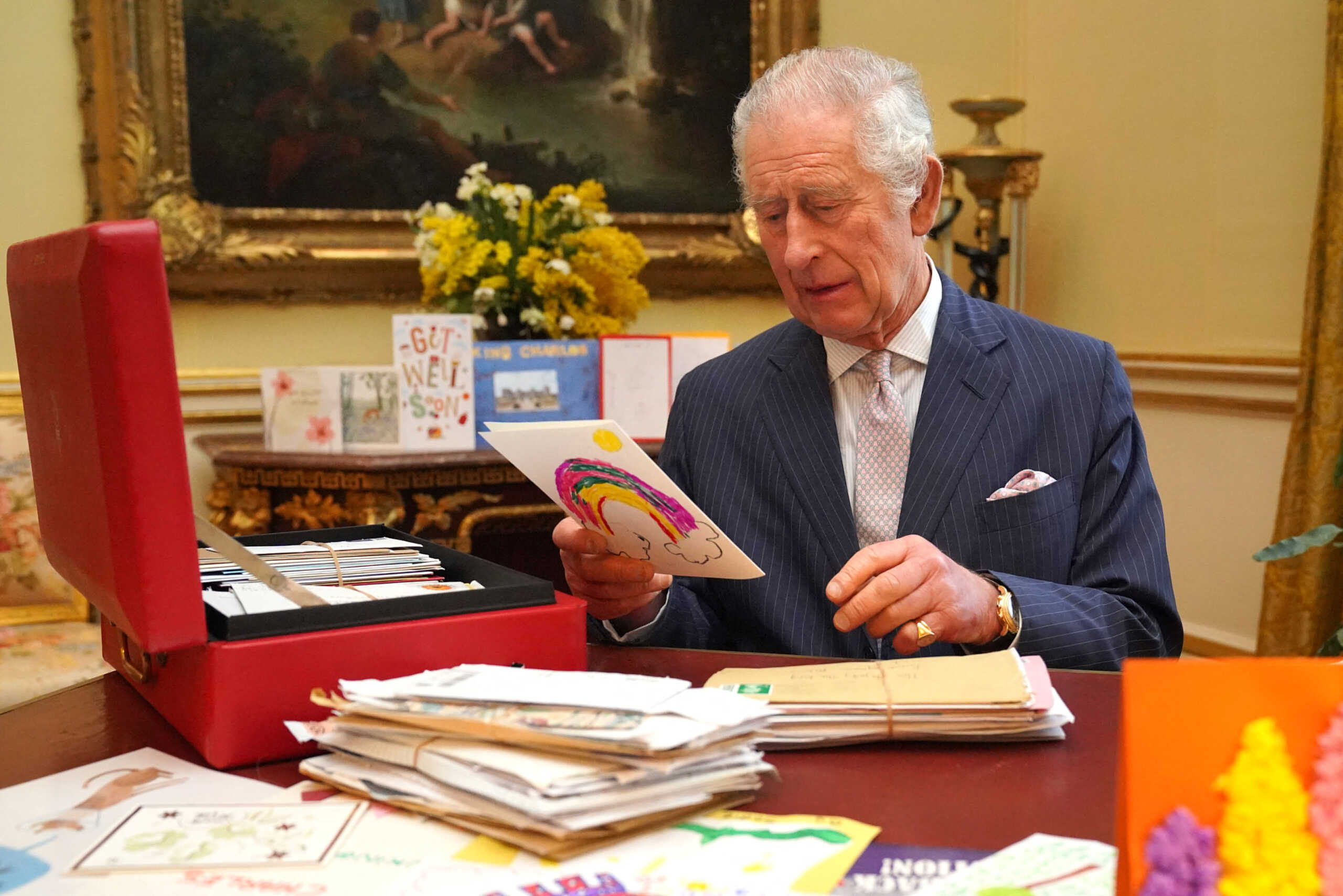 Britain's King Charles reads cards and messages, sent by well-wishers following his cancer diagnosis, in the 18th Century Room of the Belgian Suite in Buckingham Palace, London, Britain, February 21, 2024. Jonathan Brady