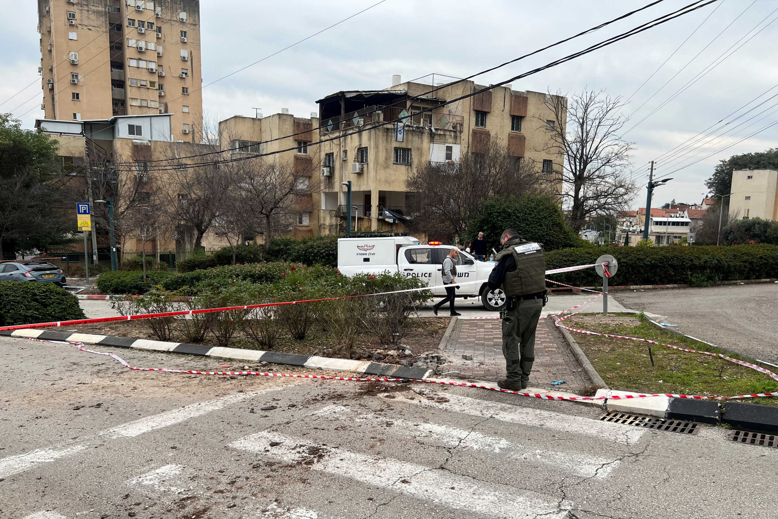 Israeli police work at the area where a rocket landed after it was fired from Lebanon, amid the ongoing conflict between Israel and the Palestinian Islamist group Hamas, in Kiryat Shmona close to Israel's border with Lebanon in northern Israel February 13, 2024. REUTERS