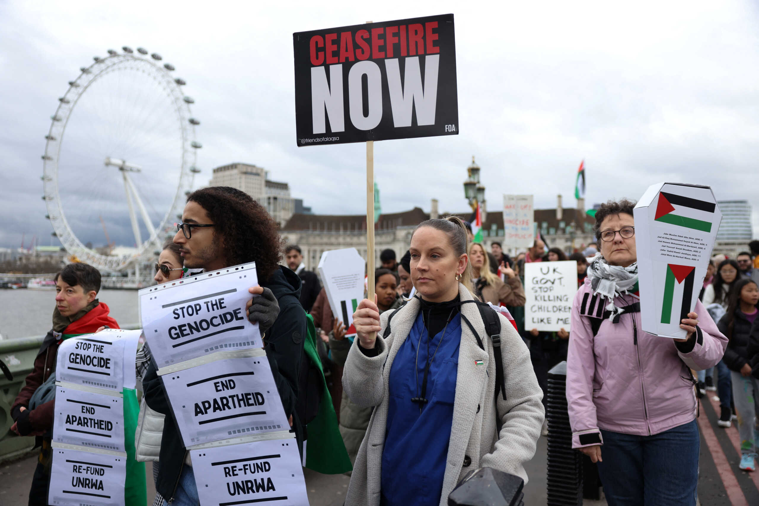 Demonstrators cross the Westminster Bridge as people participate in a silent procession during a vigil for Gaza, amid the ongoing conflict between Israel and the Palestinian Islamist group Hamas, in London, Britain February 10, 2024. REUTERS