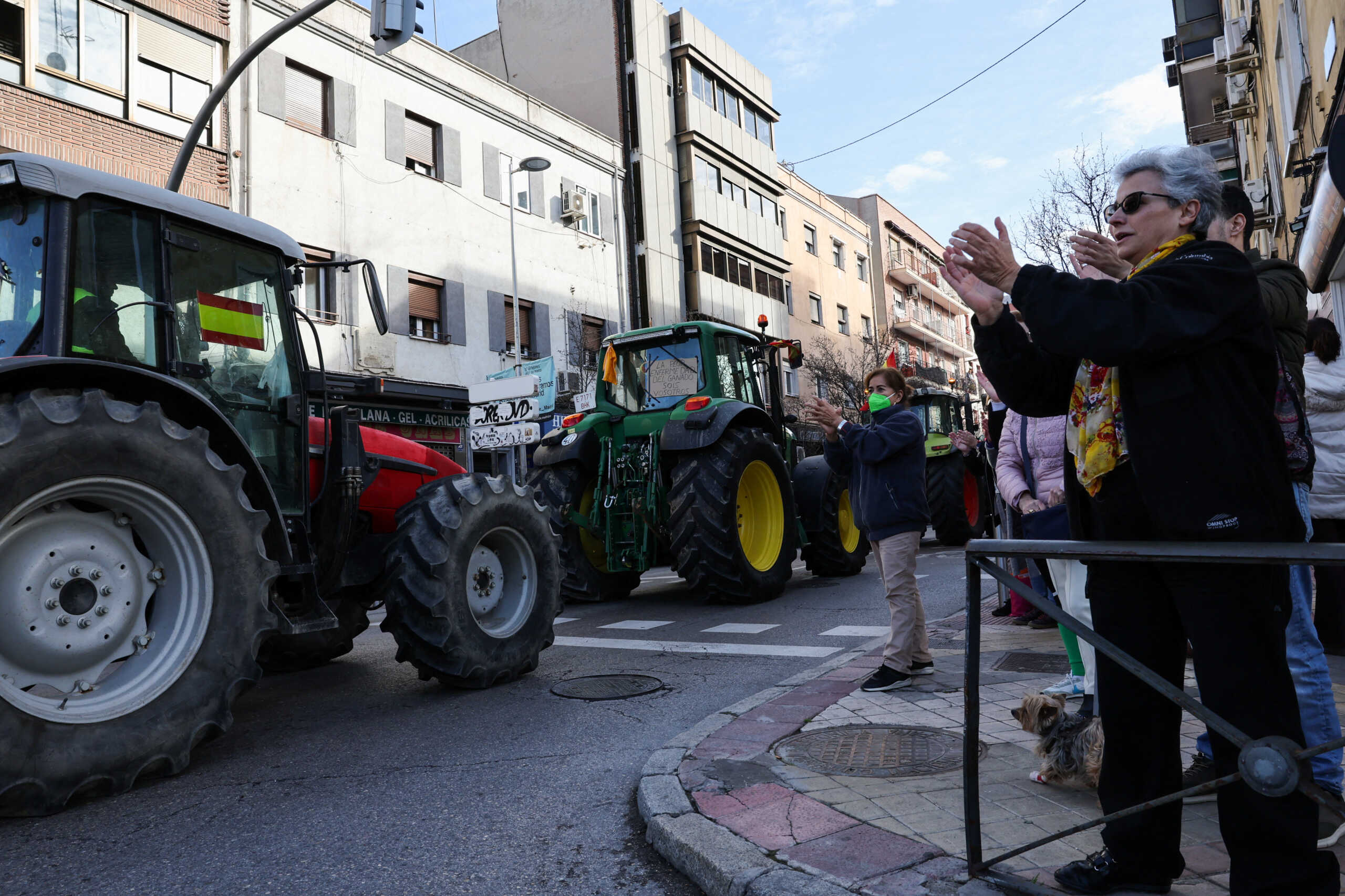 People react in support as Spanish farmers drive their tractors during a protest over price pressures, taxes and green regulation, grievances shared by farmers across Europe, in Madrid, Spain, February 21, 2024. REUTERS