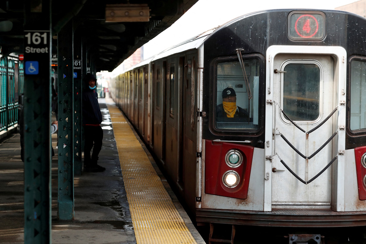 FILE PHOTO: A New York City Transit worker drives a subway train in the Bronx borough of New York City, U.S., April 21, 2020. Picture taken April 21, 2020. REUTERS