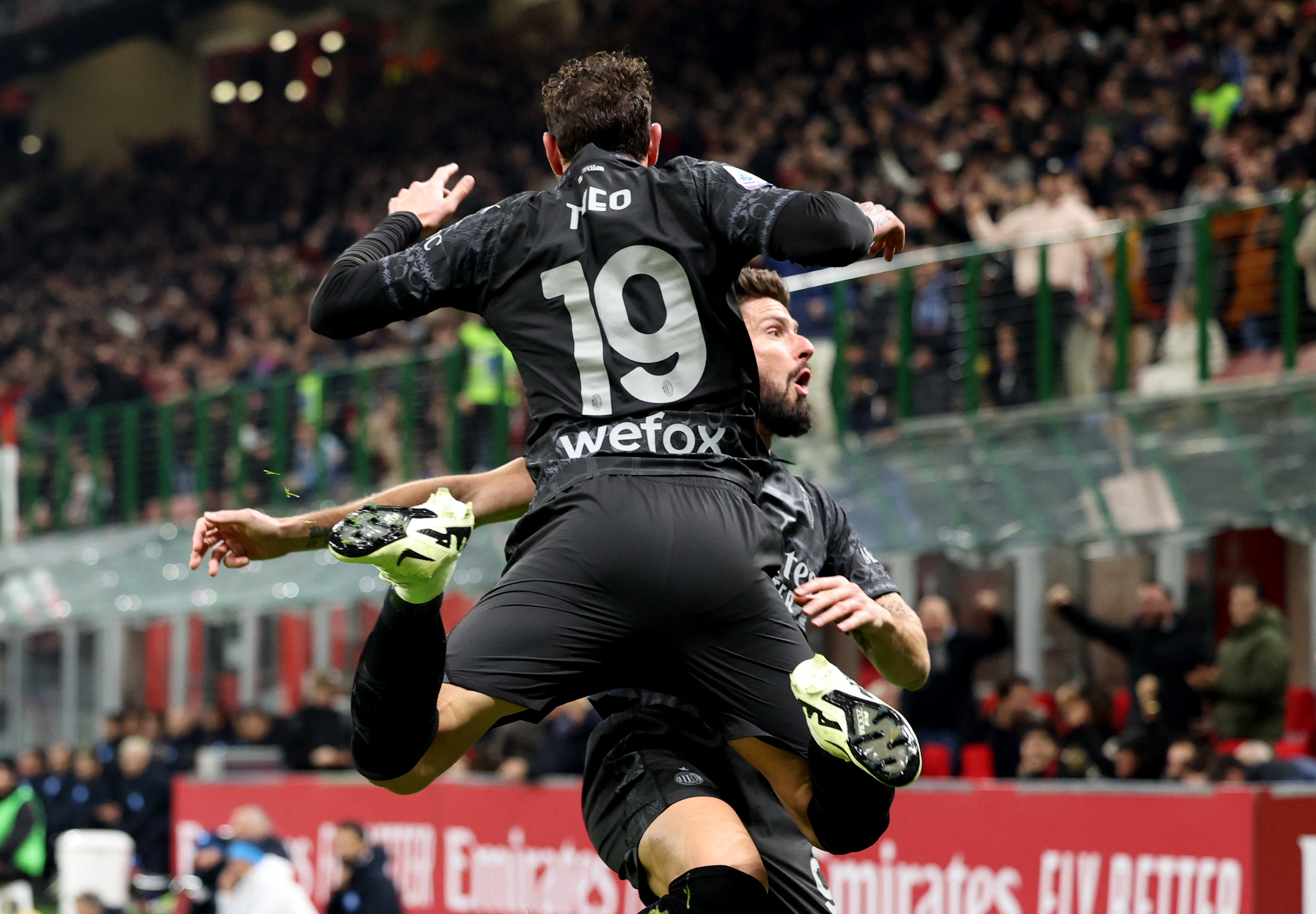 Soccer Football - Serie A - AC Milan v Napoli - San Siro, Milan, Italy - February 11, 2024 AC Milan's Theo Hernandez celebrates scoring their first goal with Olivier Giroud REUTERS