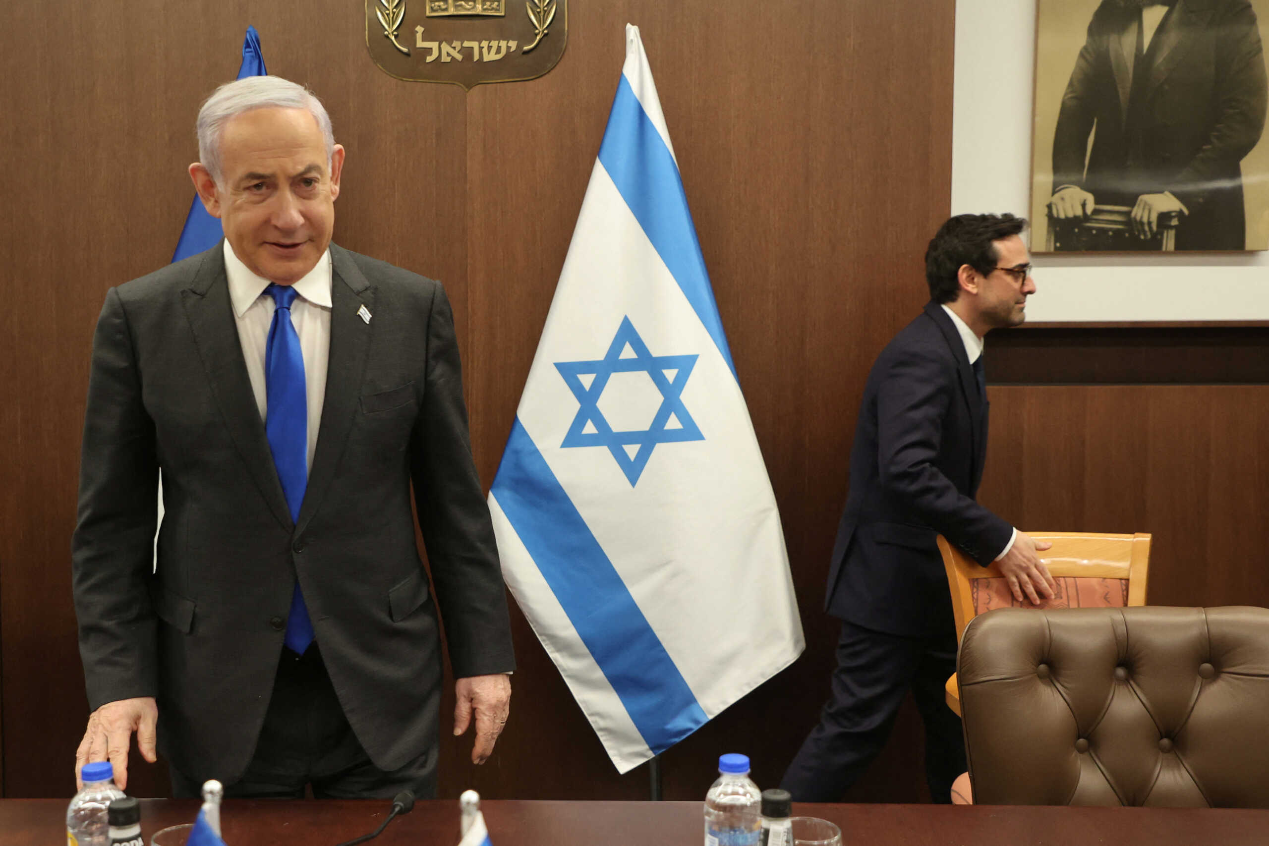 Israeli Prime Minister Benjamin Netanyahu takes a seat as he meets with French Foreign Minister Stephane Sejourne in Jerusalem on February 5, 2024.  GIL COHEN-MAGEN