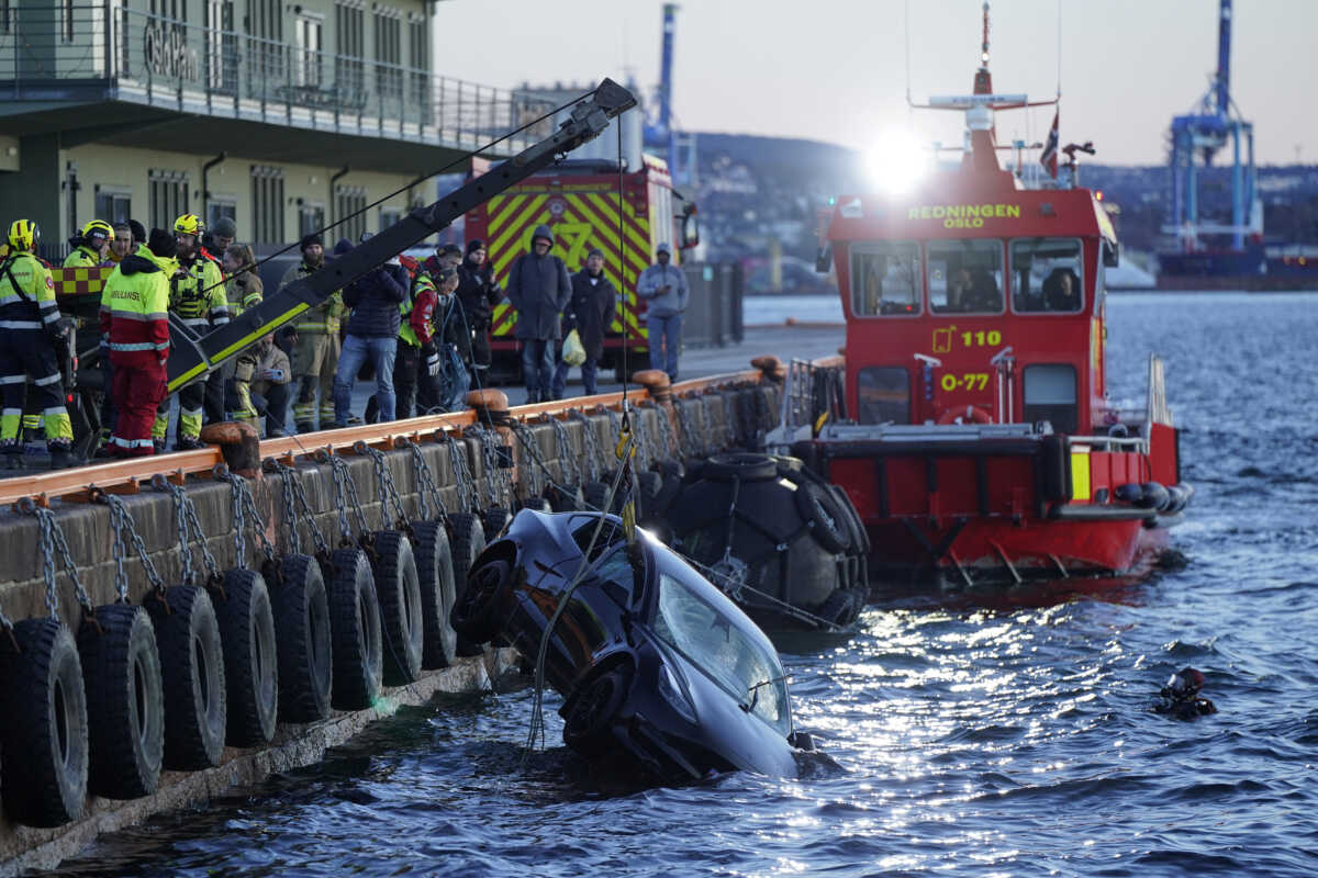 Rescuers work to retrieve a car from the Oslofjord, in Oslo, Norway, February 1, 2024. NTB