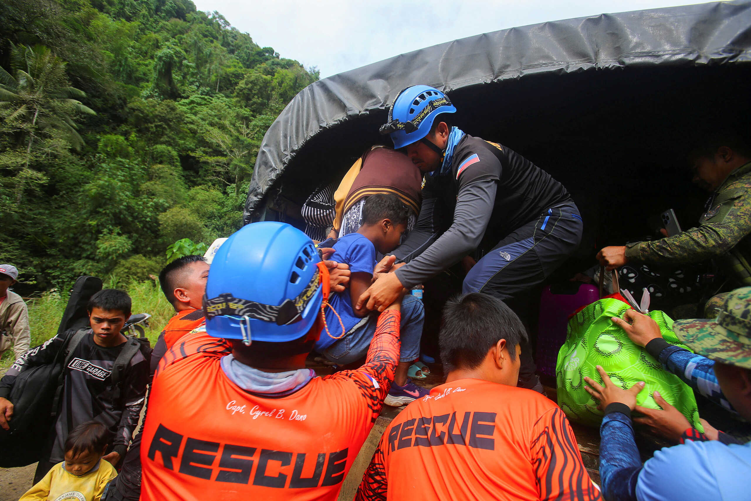 Rescuers vacate residents following a landslide in the village of Masara, Maco, Davao de Oro, Philippines, February 8, 2024. REUTERS