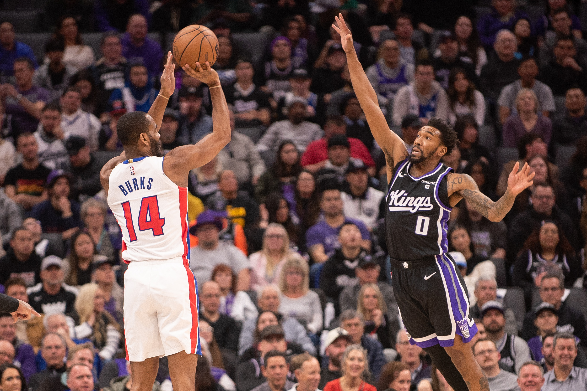 Feb 7, 2024; Sacramento, California, USA; Detroit Pistons guard Alec Burks (14) takes a shot over Sacramento Kings guard Malik Monk (0) during the first quarter at Golden 1 Center. Mandatory Credit: Ed Szczepanski-USA TODAY Sports